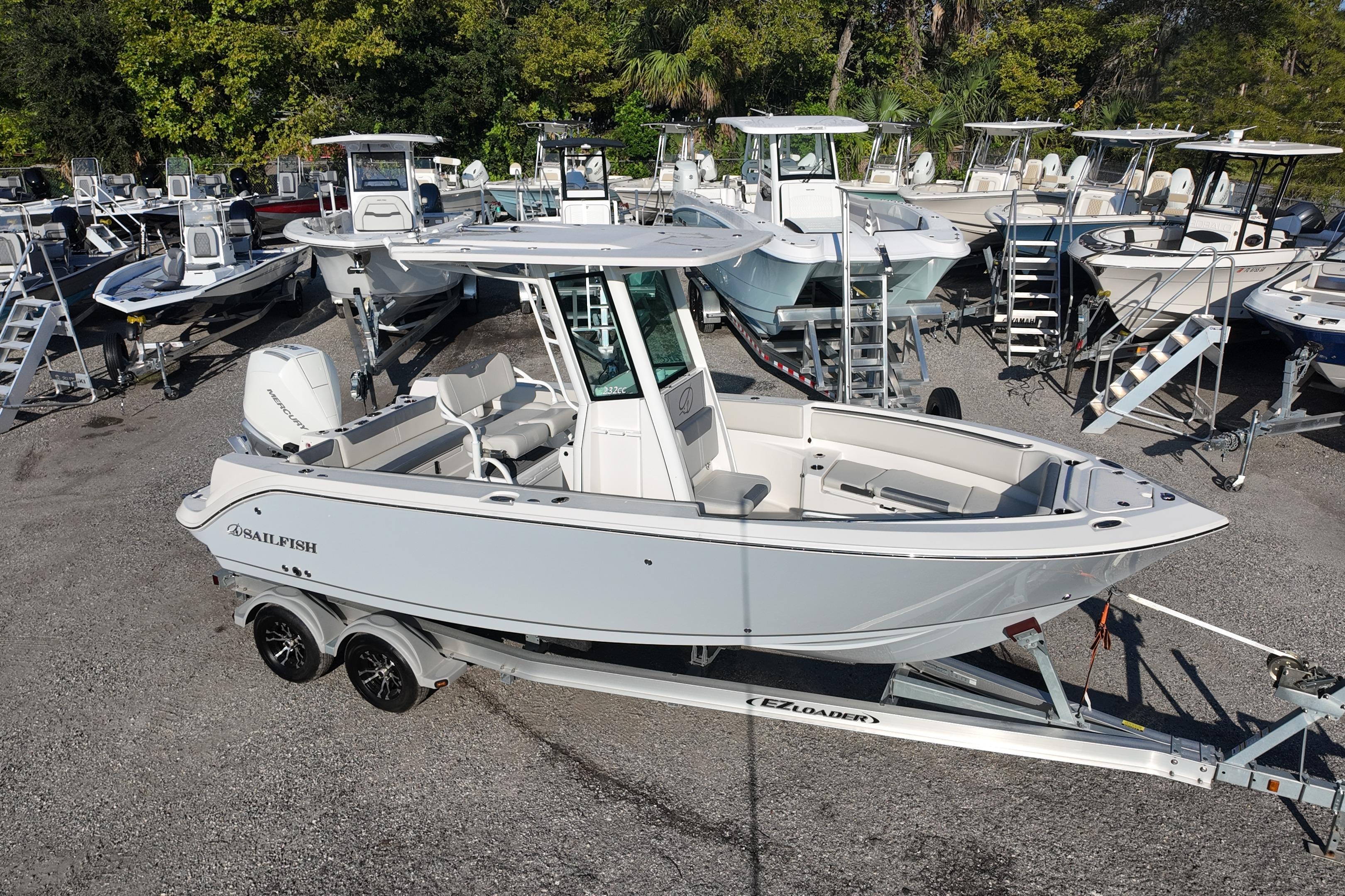 2026 Sailfish 232 CC boat on trailer, surrounded by other boats in a dealership lot.