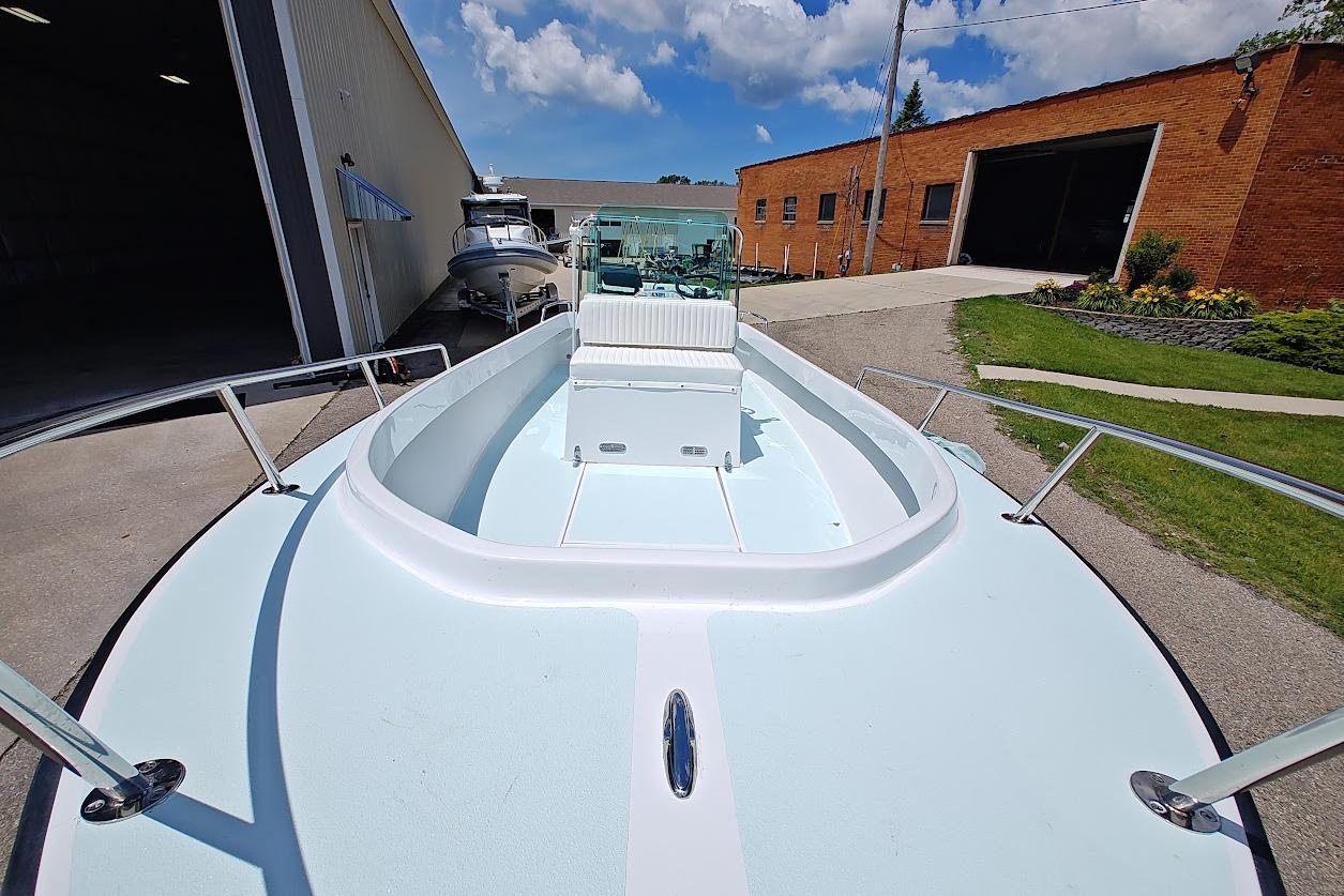 1975 Shamrock 200 Open boat docked outside, showcasing spacious deck and sleek design.