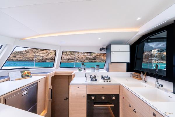 Modern kitchen interior of 2025 Nautitech 44 Open yacht with scenic ocean view.