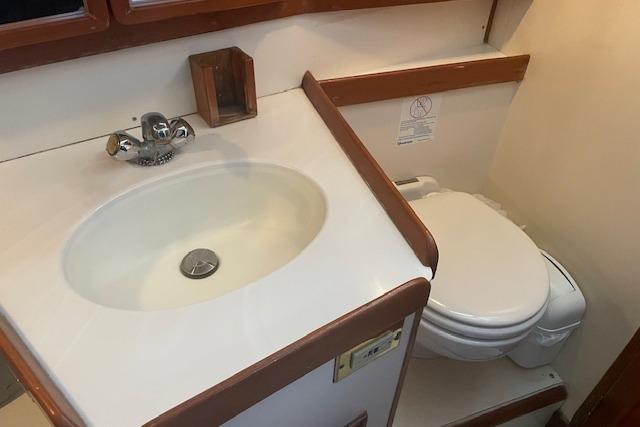 Bathroom interior of a 2001 Tartan 3700 yacht, featuring a sink and toilet.