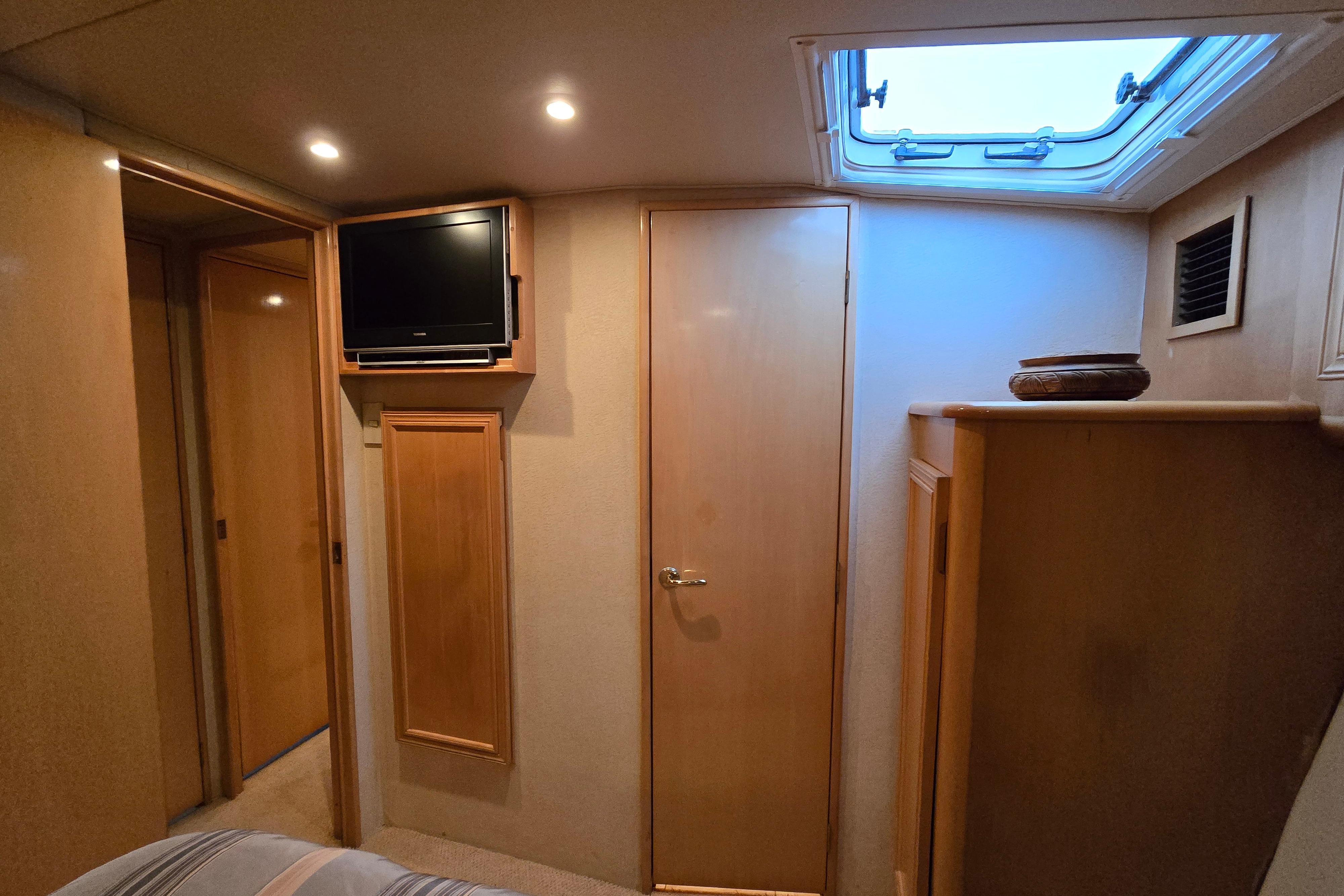 Interior of 2001 Cavileer 53 Convertible yacht with TV and skylight.