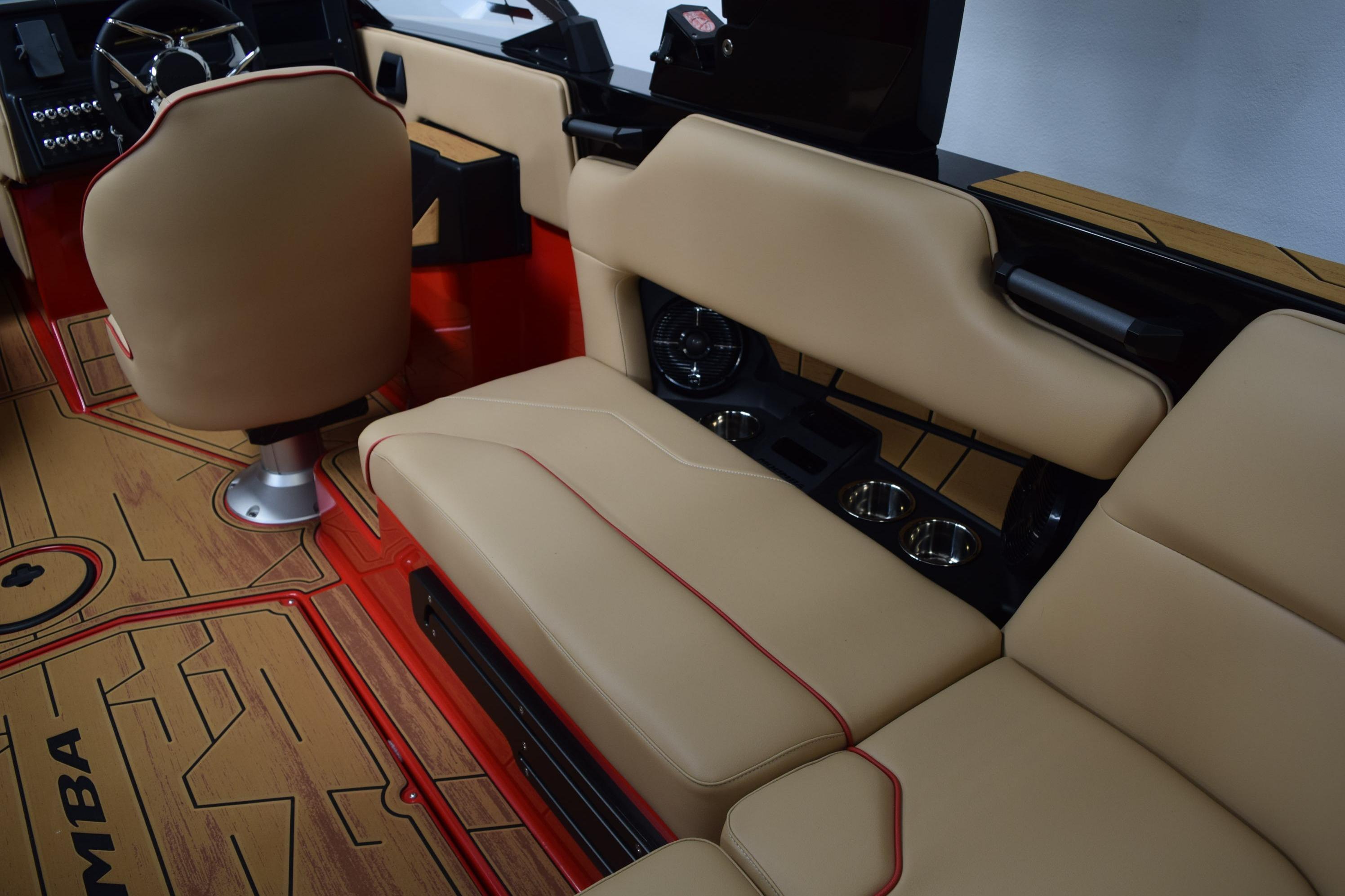 2026 Moomba Max boat interior with beige seating and red accents.