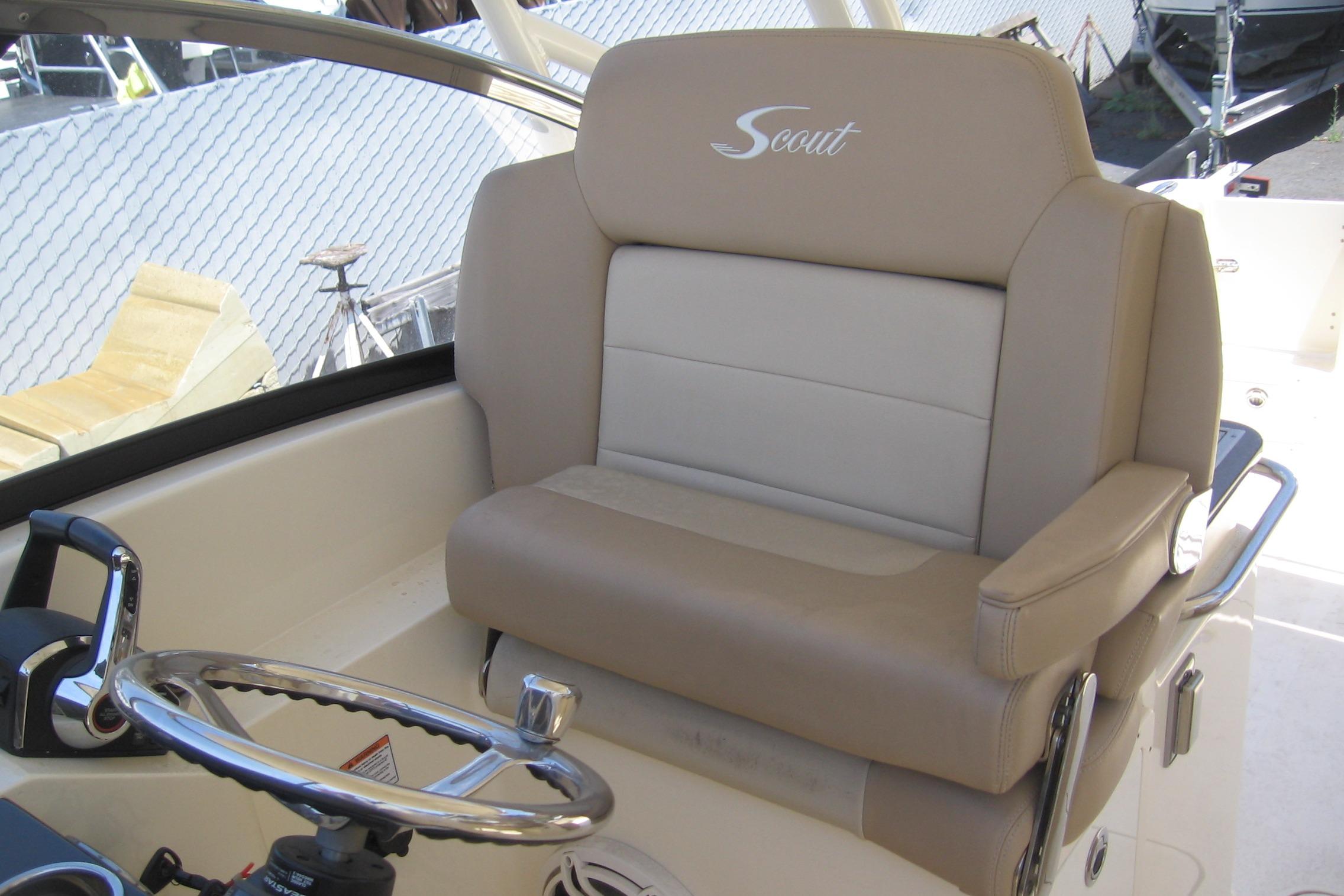2024 Scout 255 Dorado boat helm with beige leather seating and steering wheel.