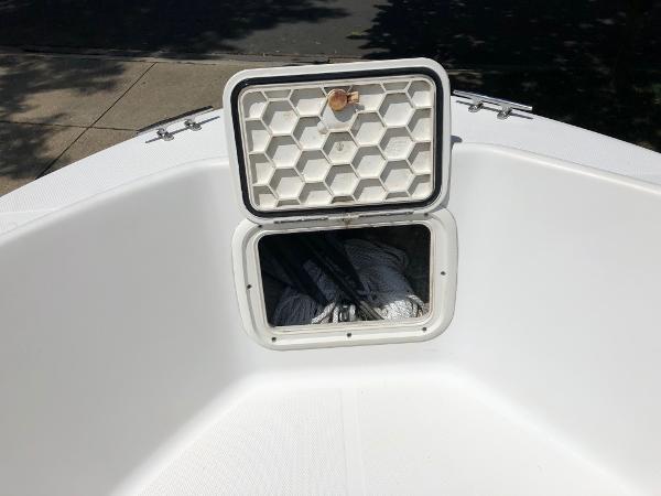 2003 Wellcraft 180 Fisherman boat storage compartment with open hatch, showing interior space.