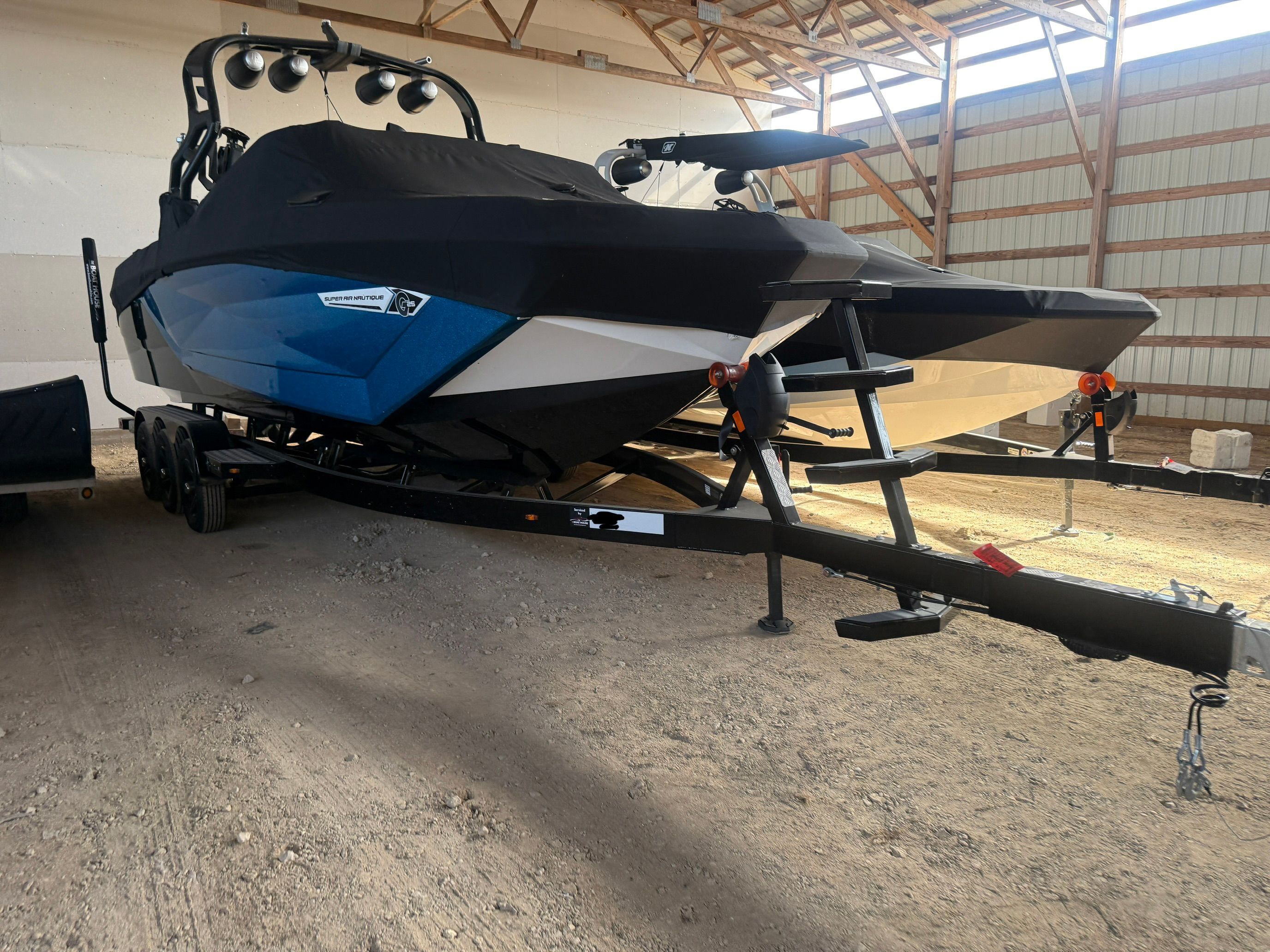 2021 Nautique Super Air Nautique G25 on trailer in storage facility.