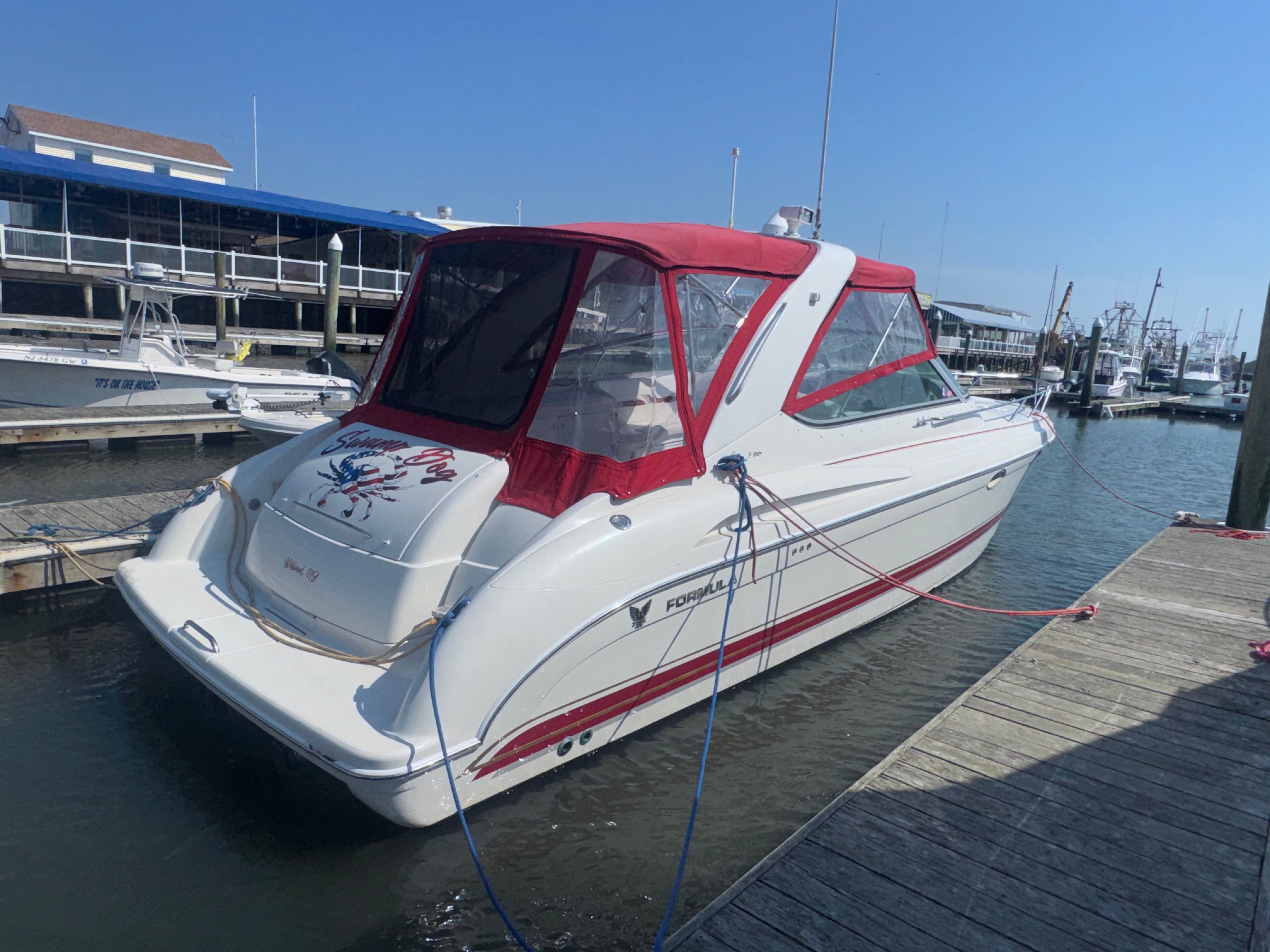 2001 Formula 37 Super Sport boat docked with red canopy.