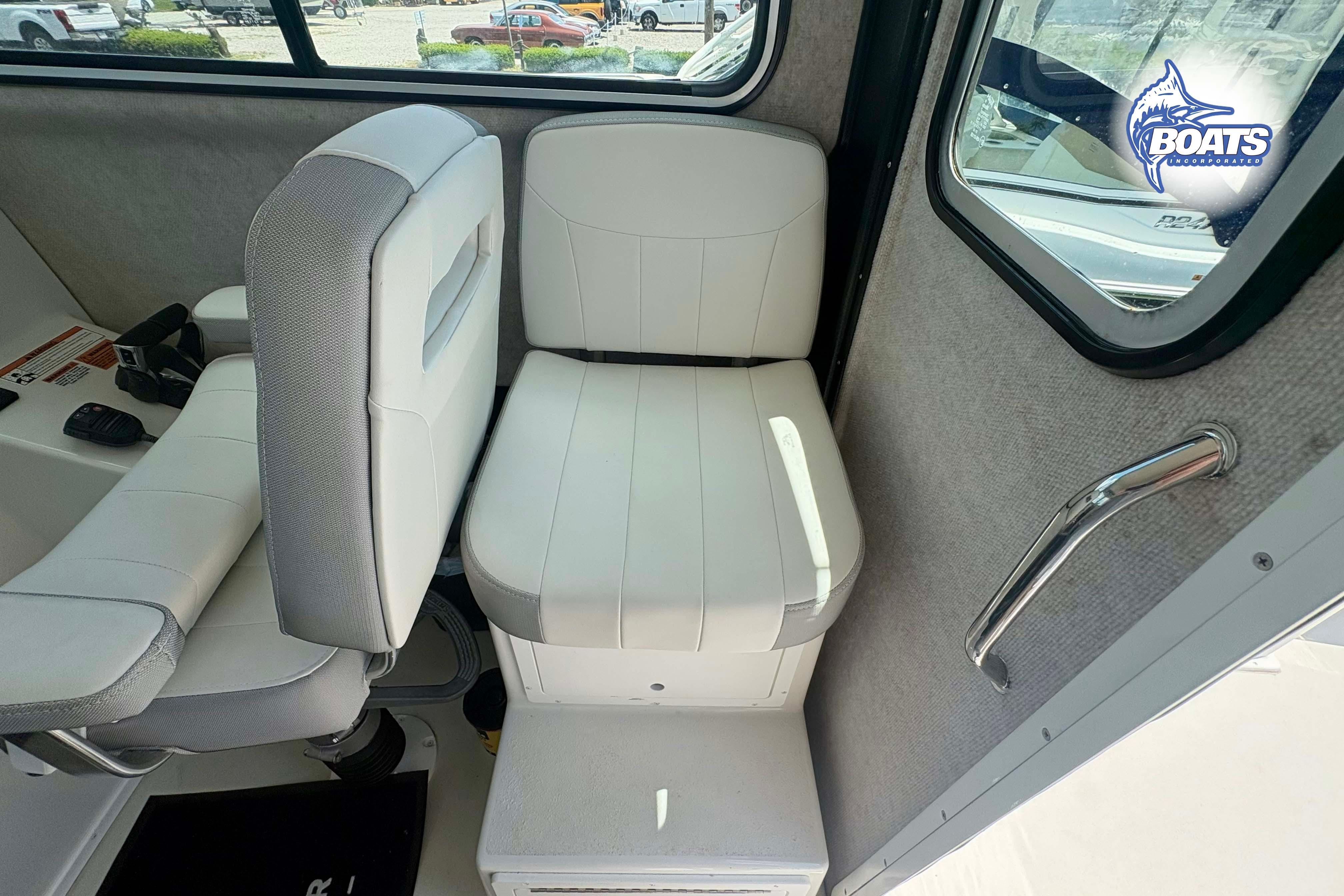 Interior of 2021 Parker 2520 XLD Sport Cabin with white seating and window view.