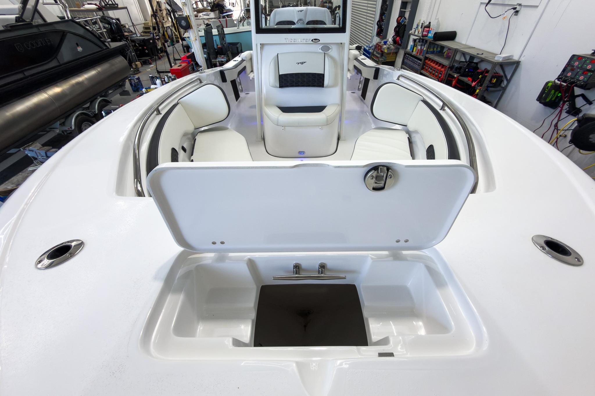 The image shows the deck of a Tidewater 220 LXF boat with seating and storage space.