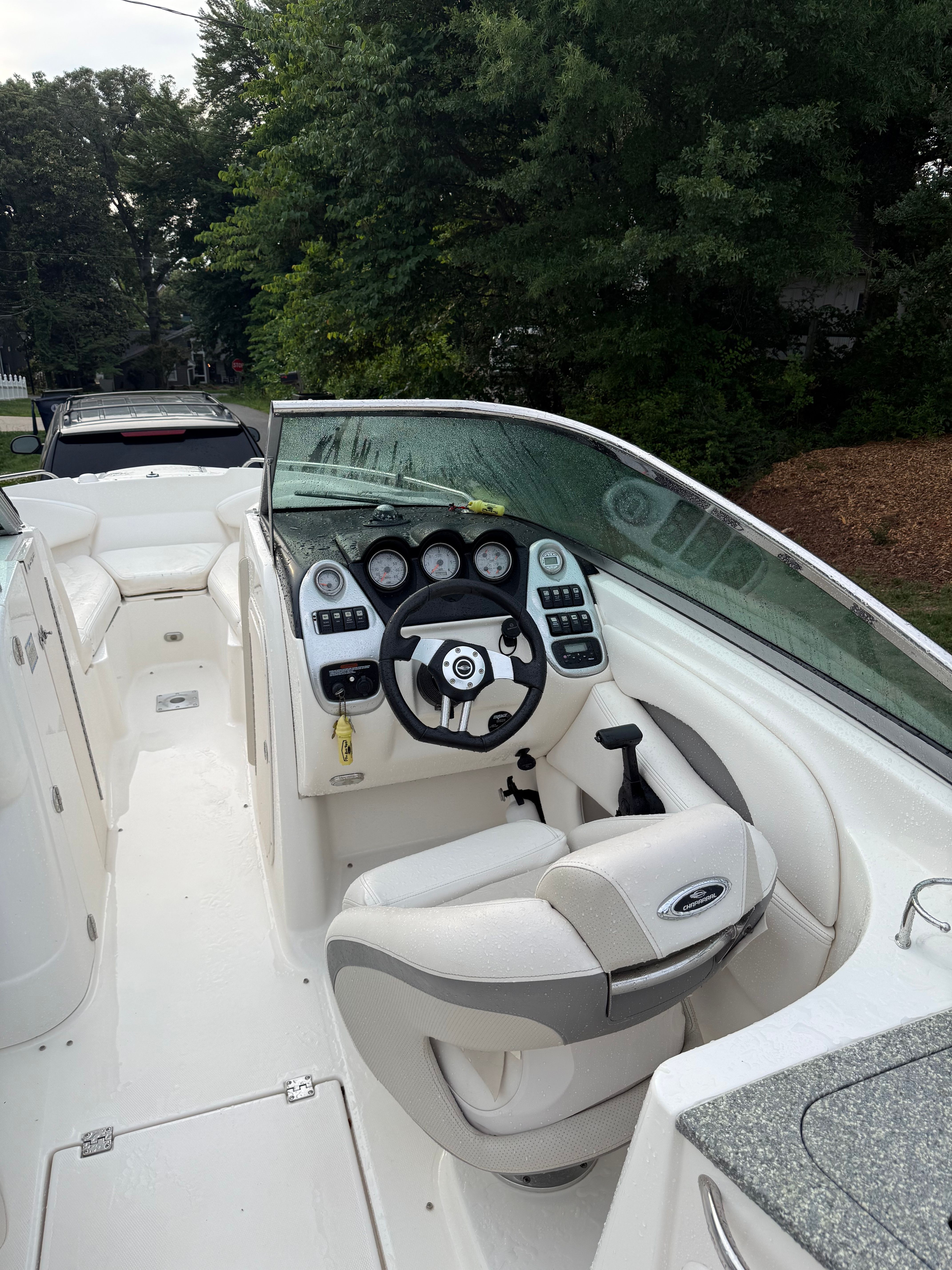 The image shows the cockpit of a 2007 Chaparral 256 SSX boat with a sleek helm.