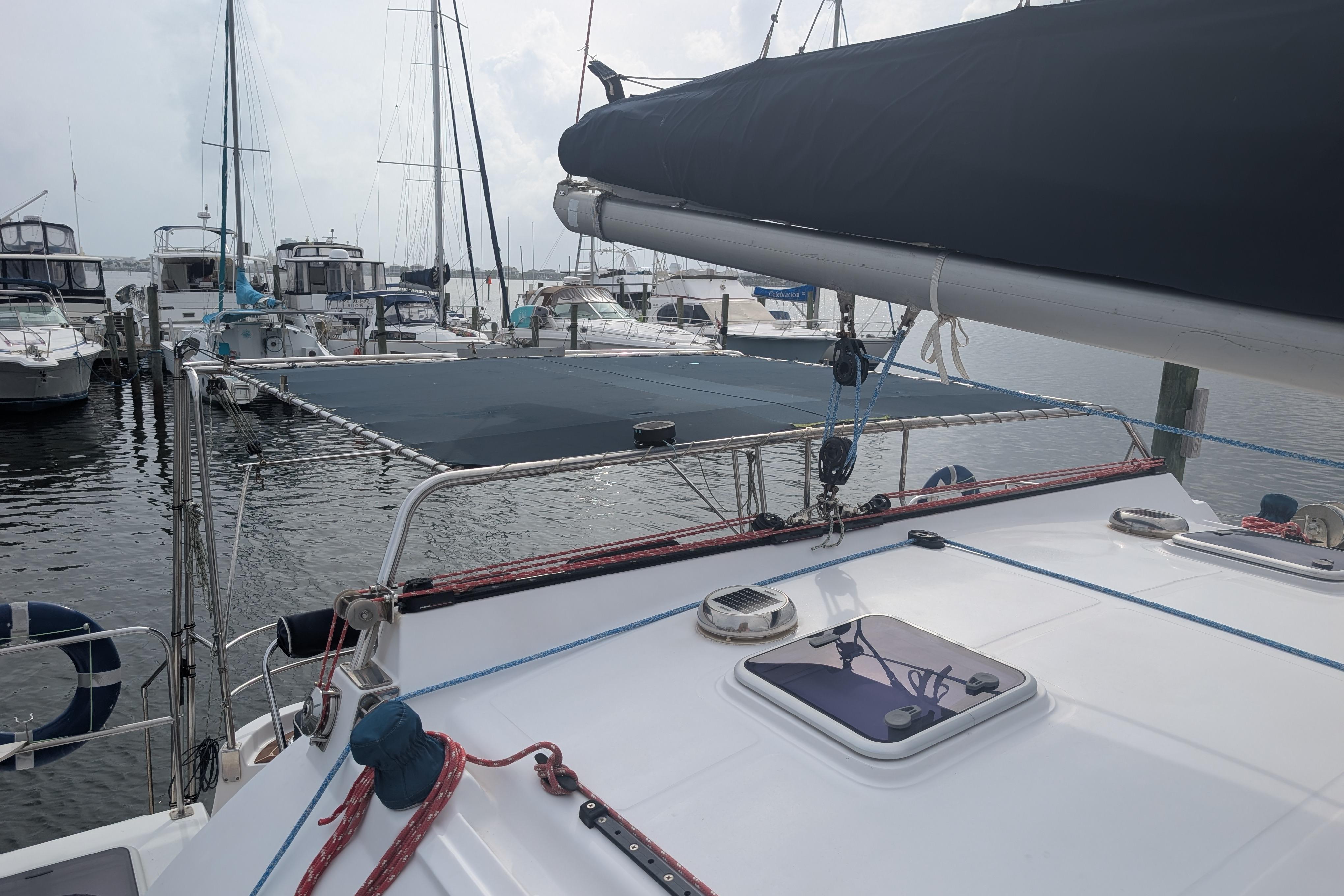 Sailboat Island Spirit 37, 1999 model, docked at marina with other boats.