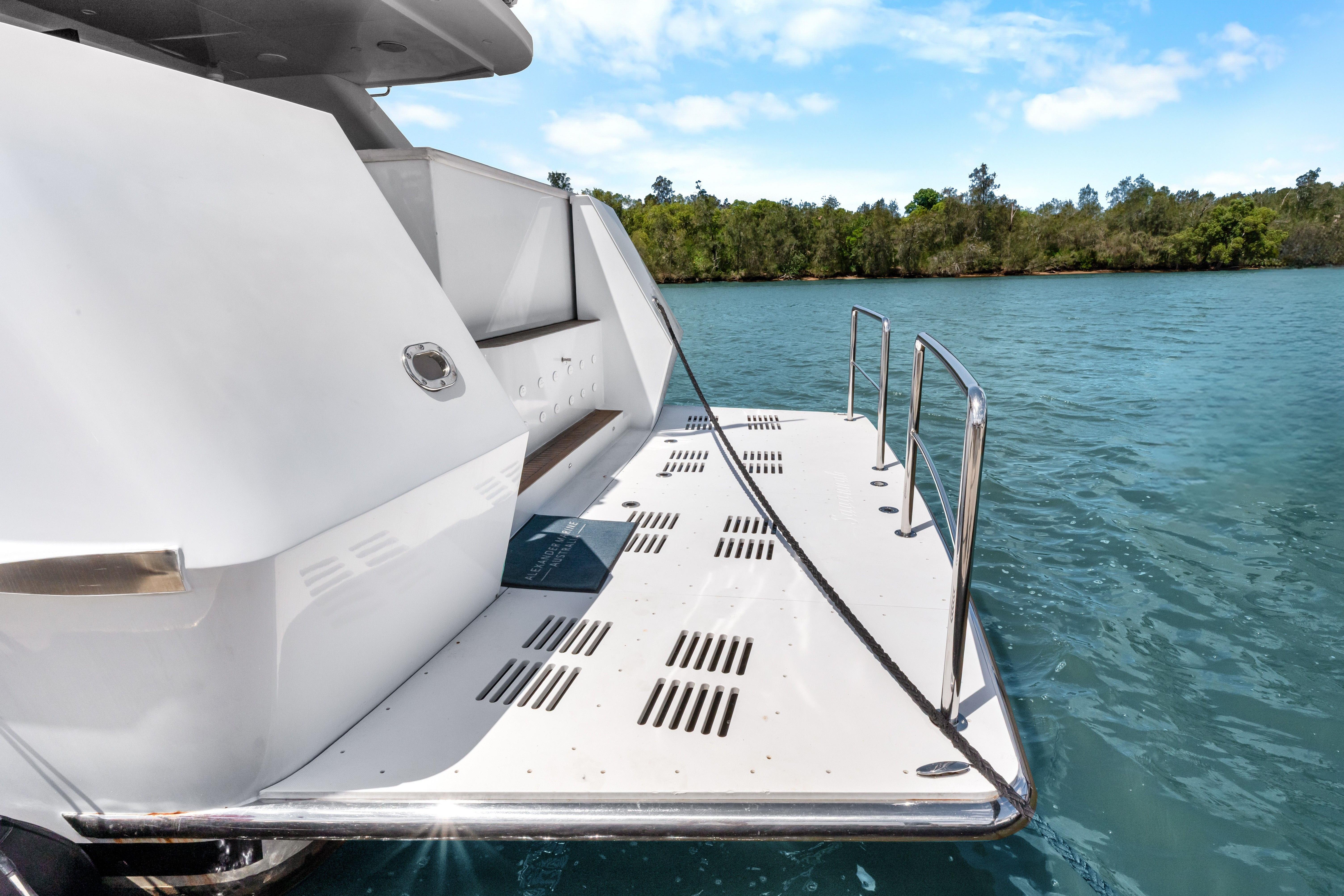 Sleek 2012 Custom 25m yacht deck with railing, docked on serene blue water.