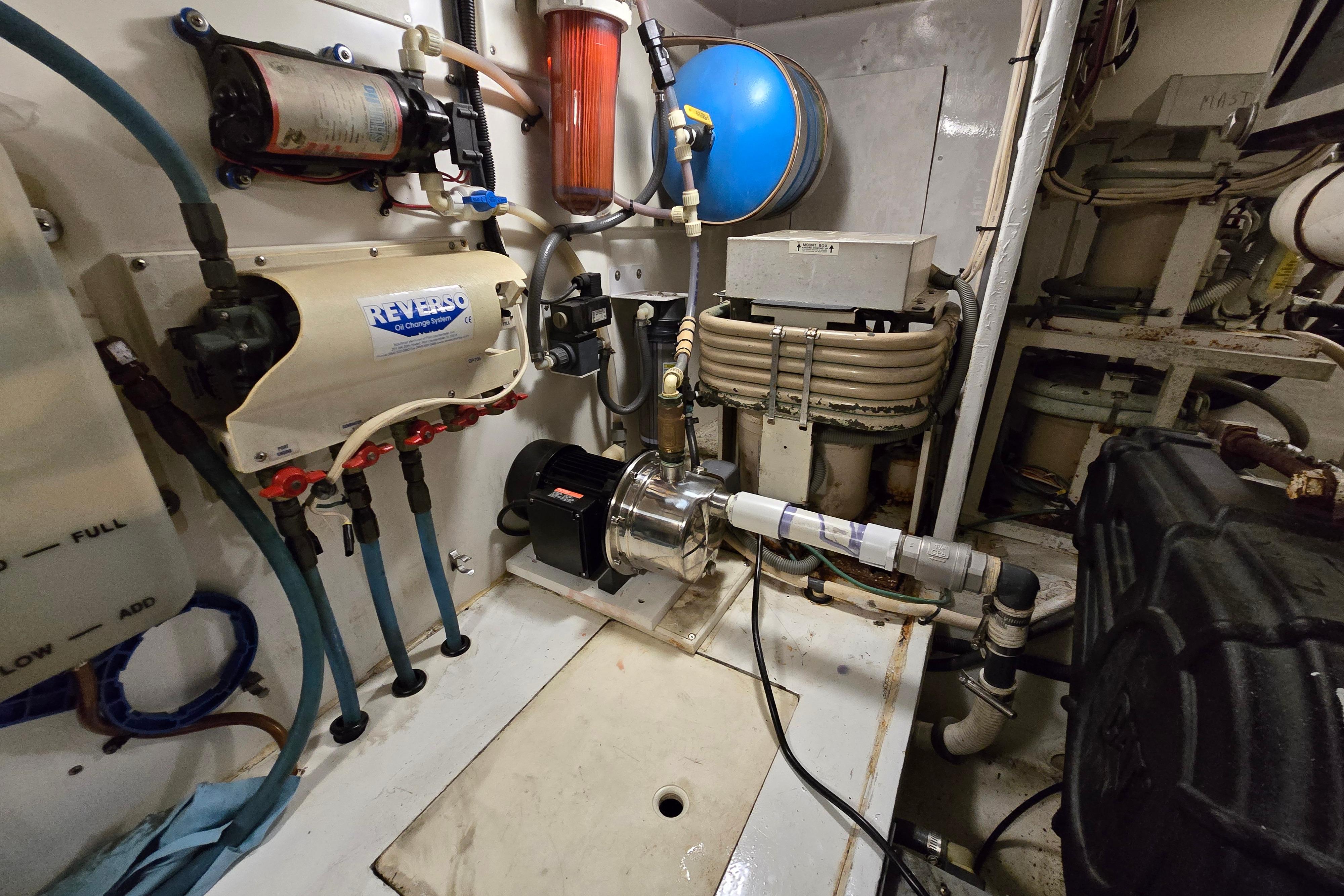 Engine room of a 2001 Cavileer 53 Convertible yacht with mechanical equipment.