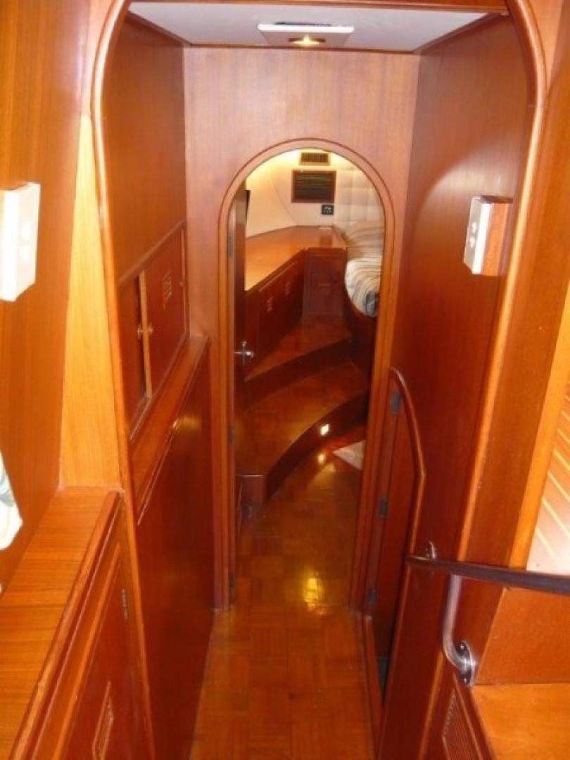 Interior of 1990 Cheoy Lee Sloop, featuring wooden paneling and cozy cabin design.