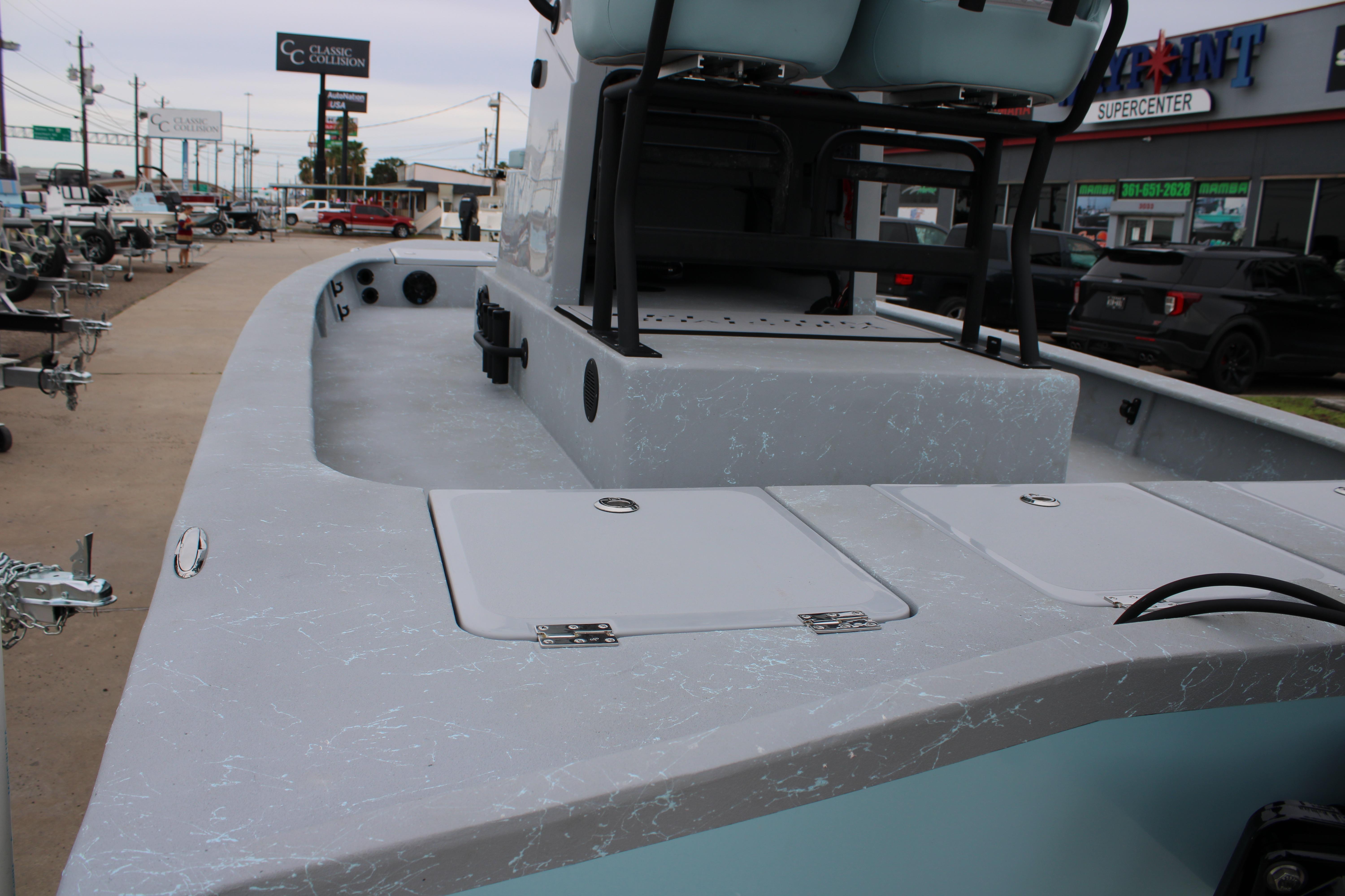 2026 Freedom Boats 24 Defender, docked, showcasing spacious deck and seating area.
