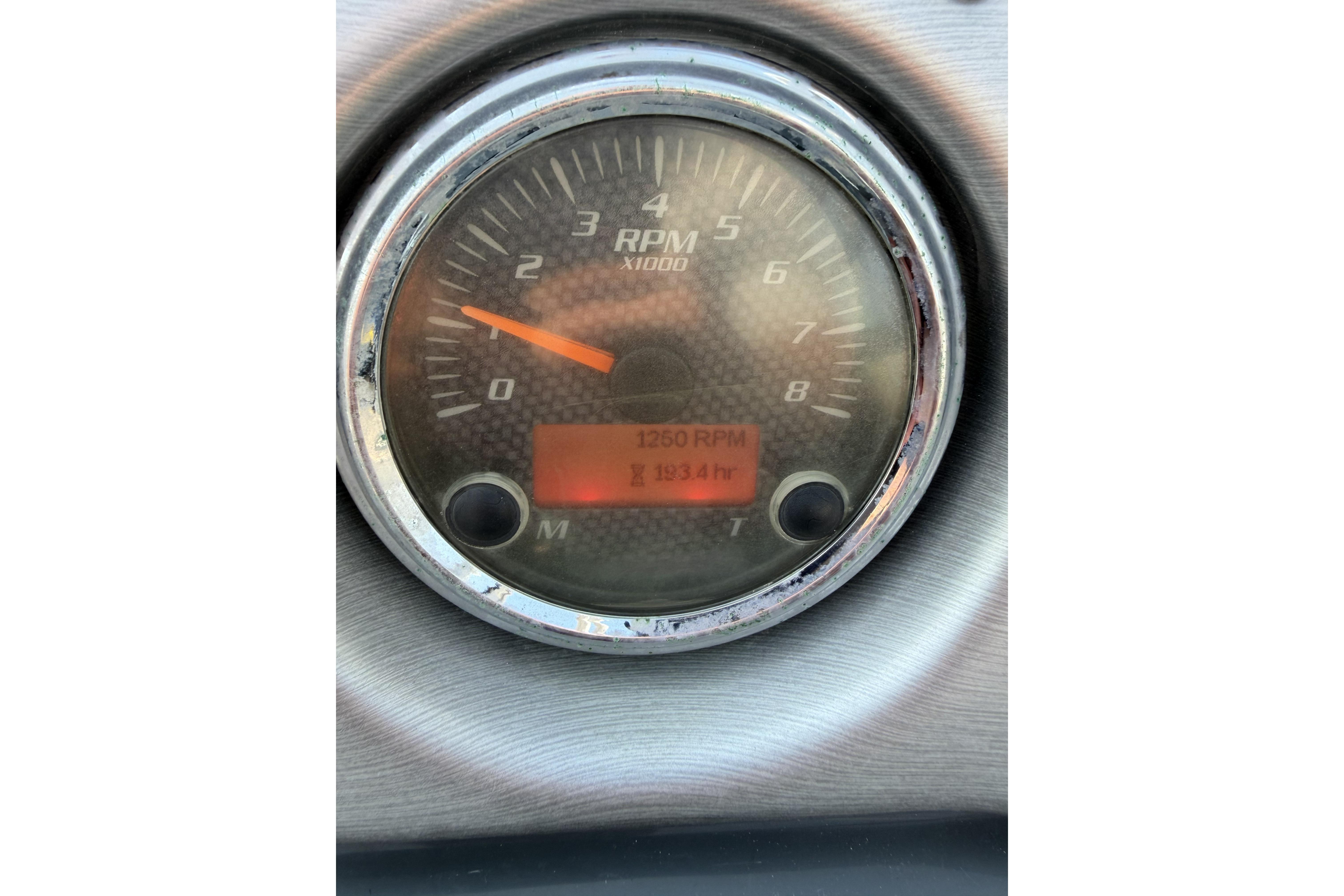 Close-up of 2011 Yamaha AR240 HO boat tachometer displaying 1250 RPM.