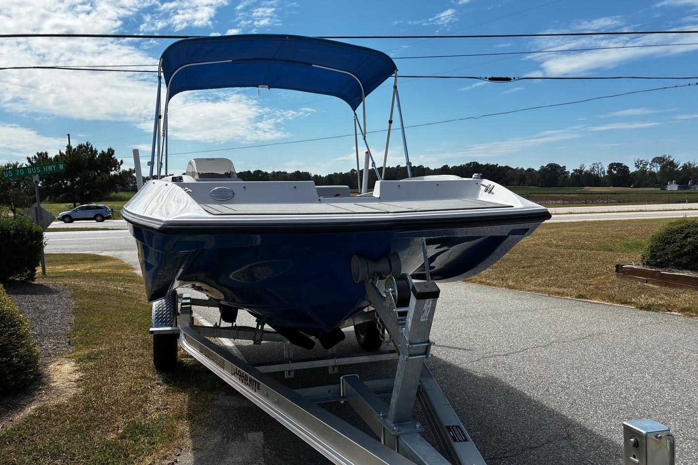 2026 Starcraft SV 16 OB boat on trailer, blue hull, parked outdoors under clear sky.