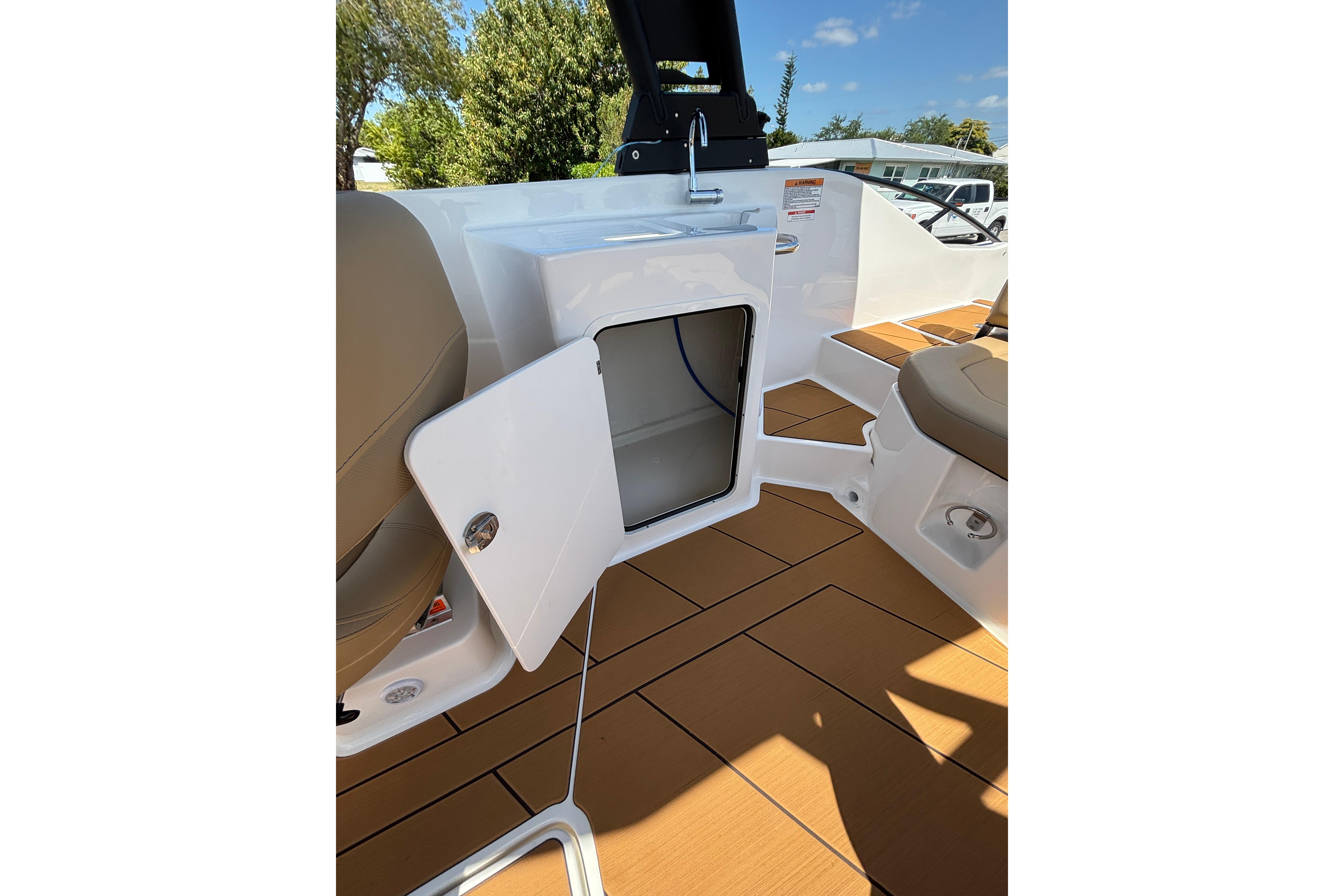 2026 Bayliner D22 boat interior with open storage compartment and seating.