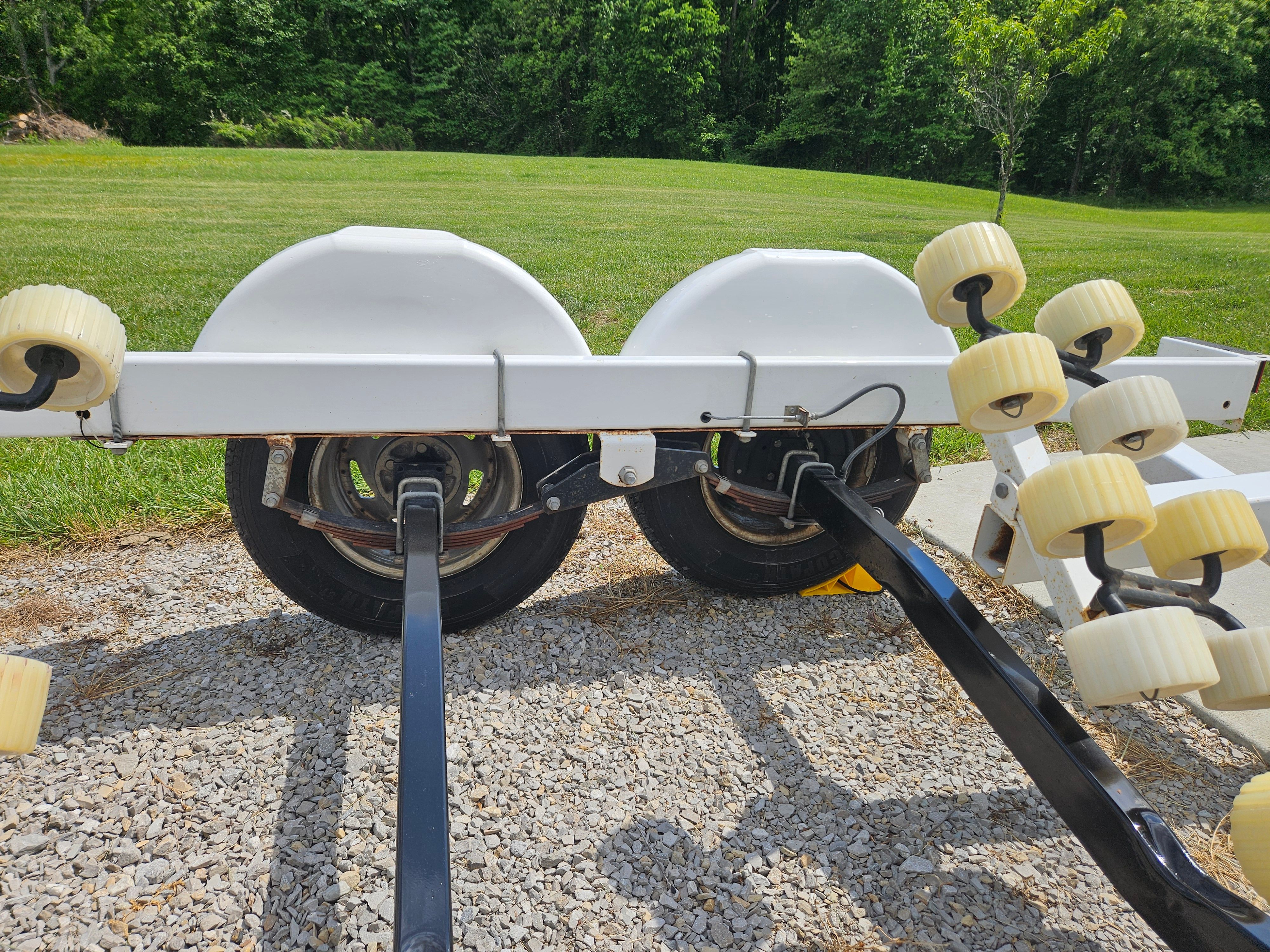 Yacht Club R2466TB boat trailer, 2010 model, on gravel surface.