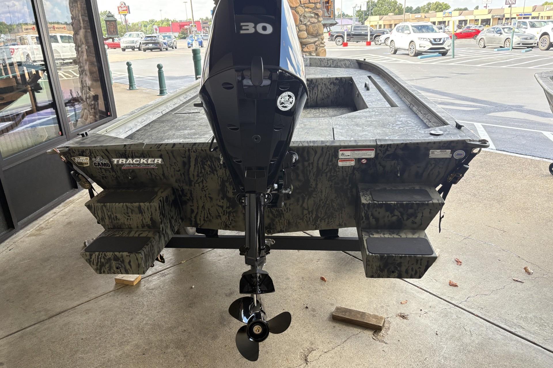 2026 Tracker Grizzly 1654 T Sportsman boat with camo design and 30 HP motor.