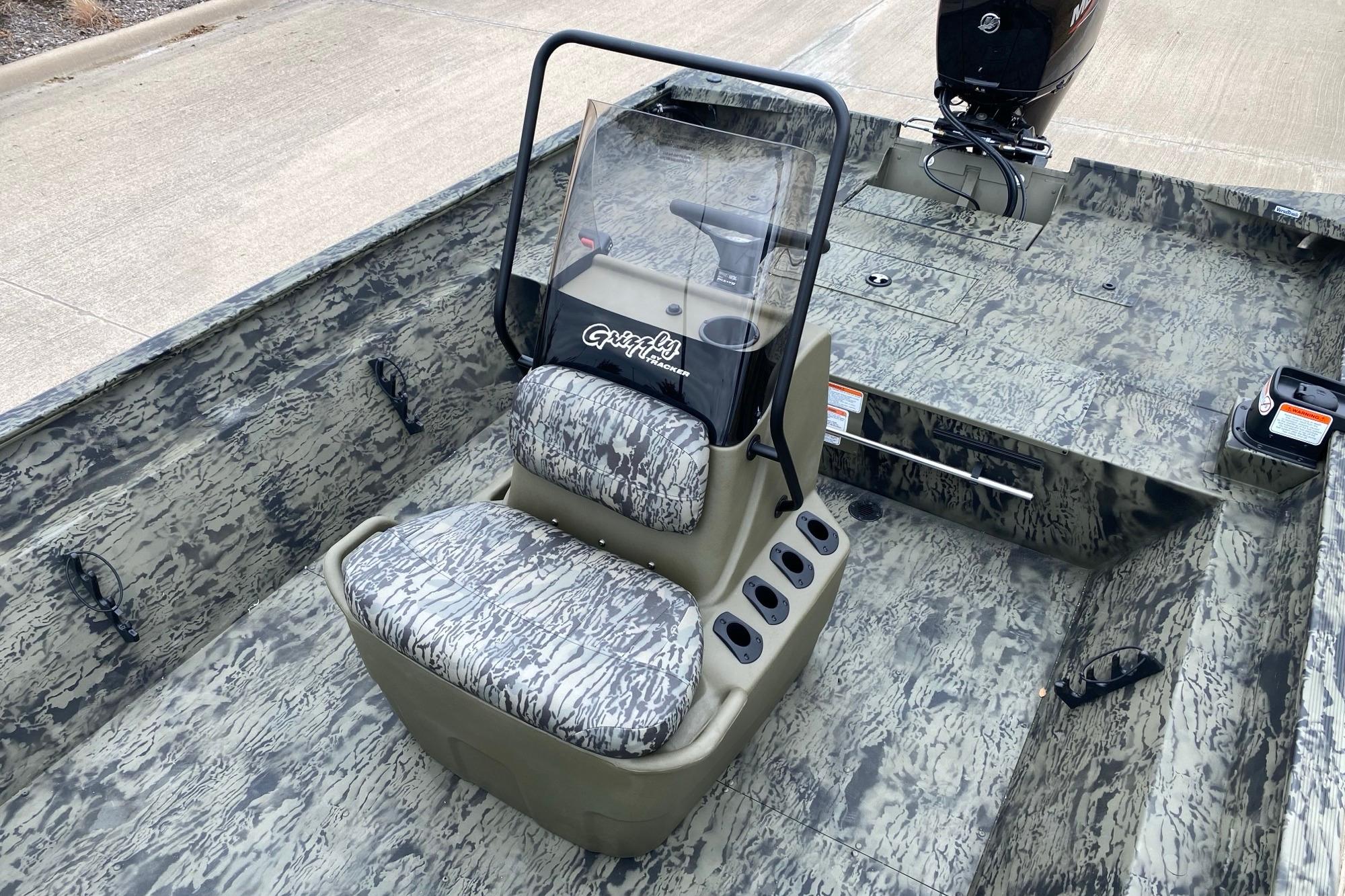 2026 Tracker Grizzly 2072 CC boat interior with camouflage design and central console.