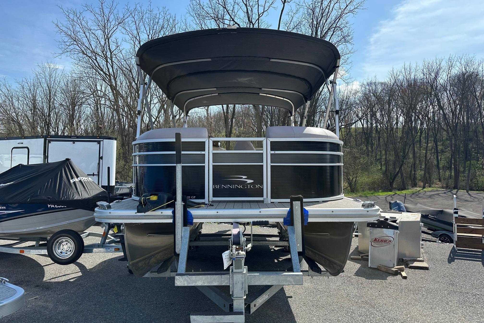 2017 Bennington 22 GPD pontoon boat on trailer, parked outdoors.