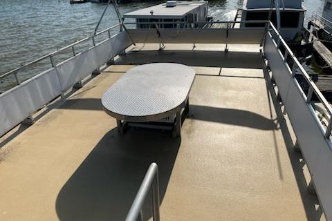 1995 Myacht 40X13 houseboat deck with table, railing, and waterfront view.