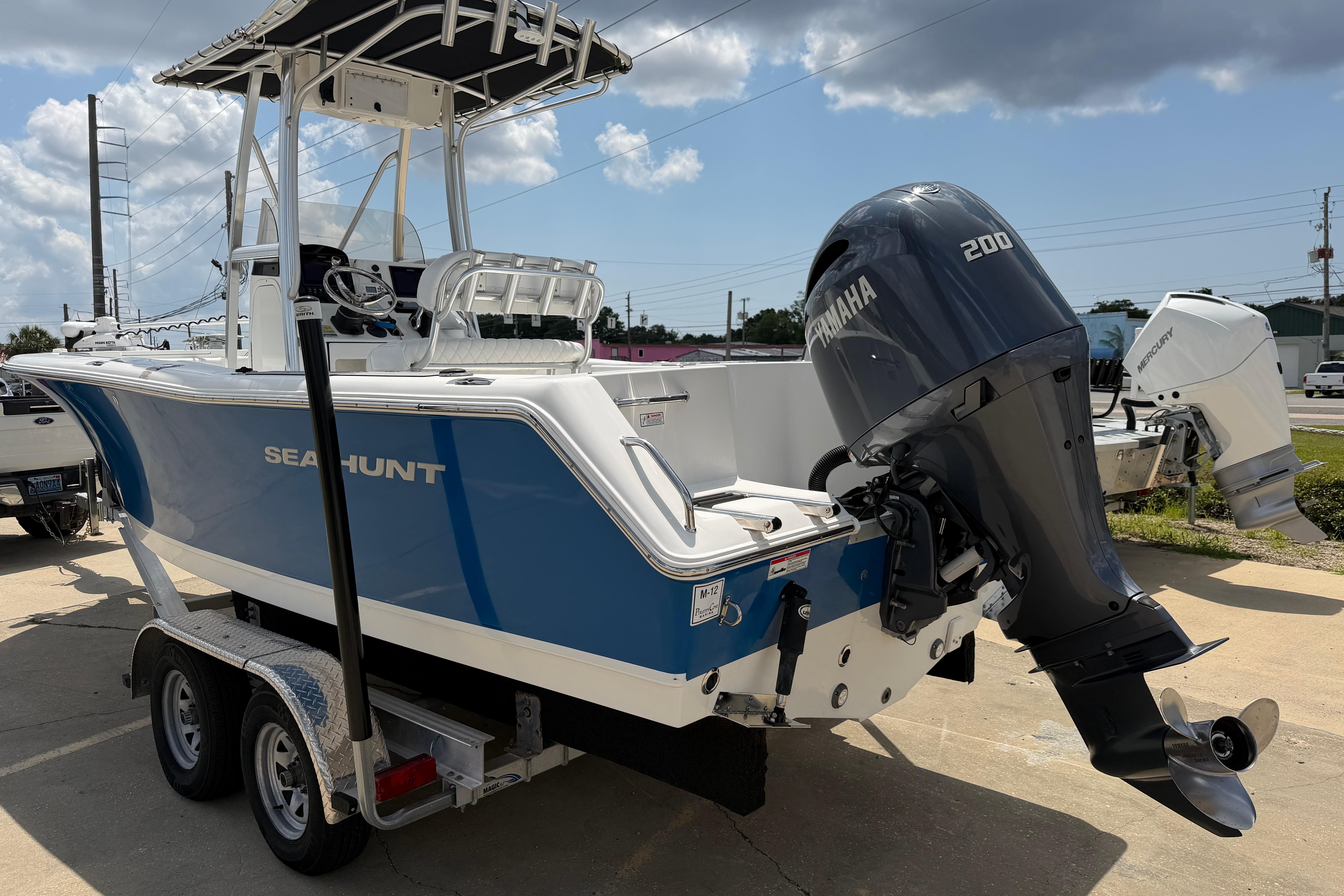 2015 Sea Hunt Triton 225 boat with Yamaha 200 outboard motor on trailer.