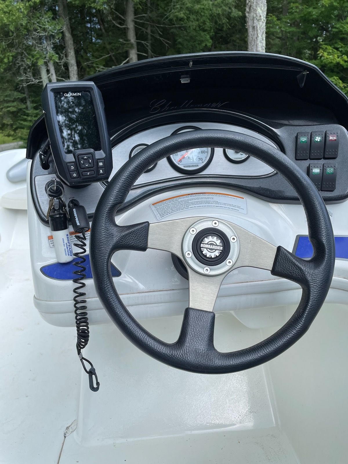 Steering wheel of a 2004 Bombardier Challenger boat with Garmin device.