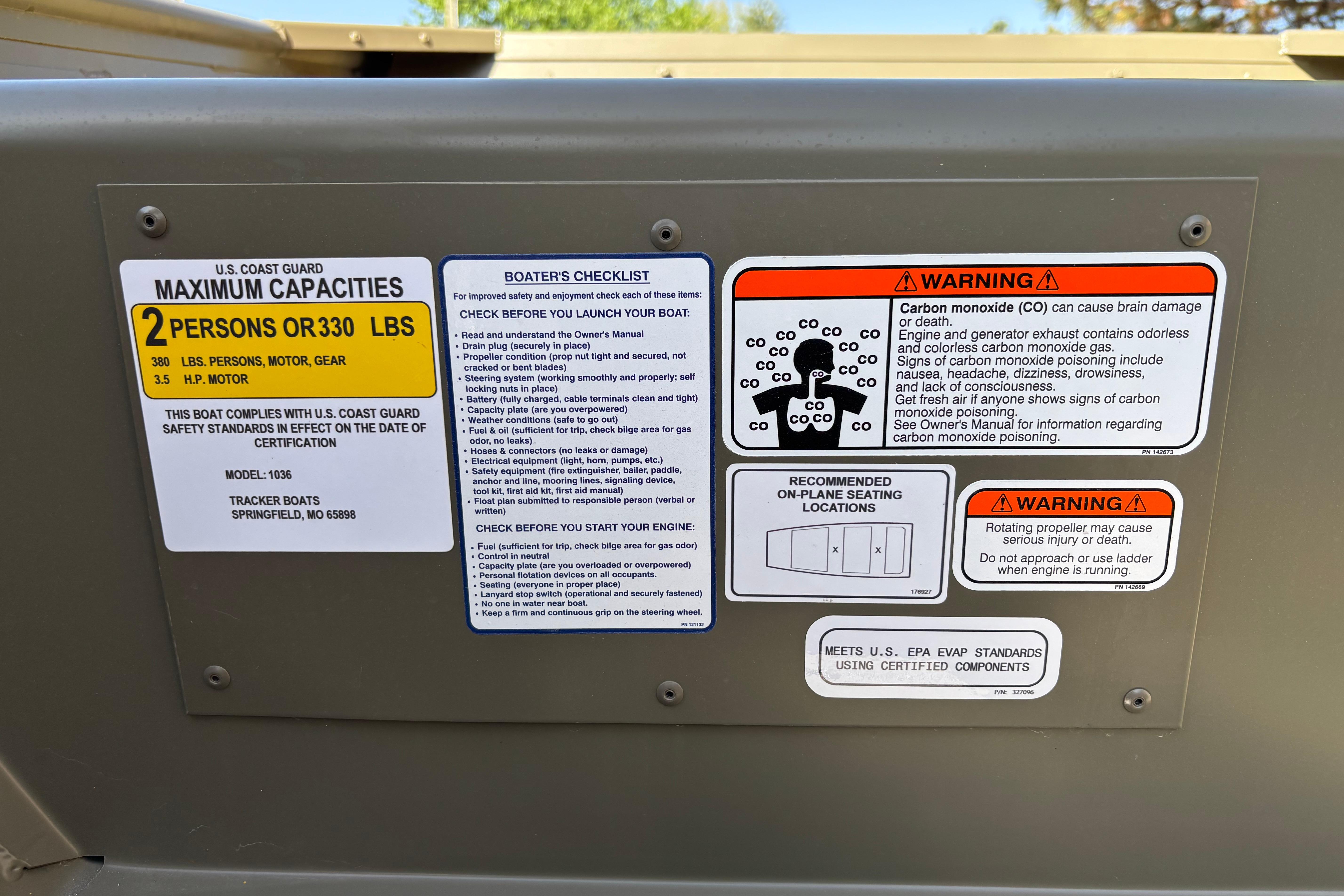 2026 Tracker Grizzly 10 Jon boat safety labels and warnings, including capacity and carbon monoxide risks.
