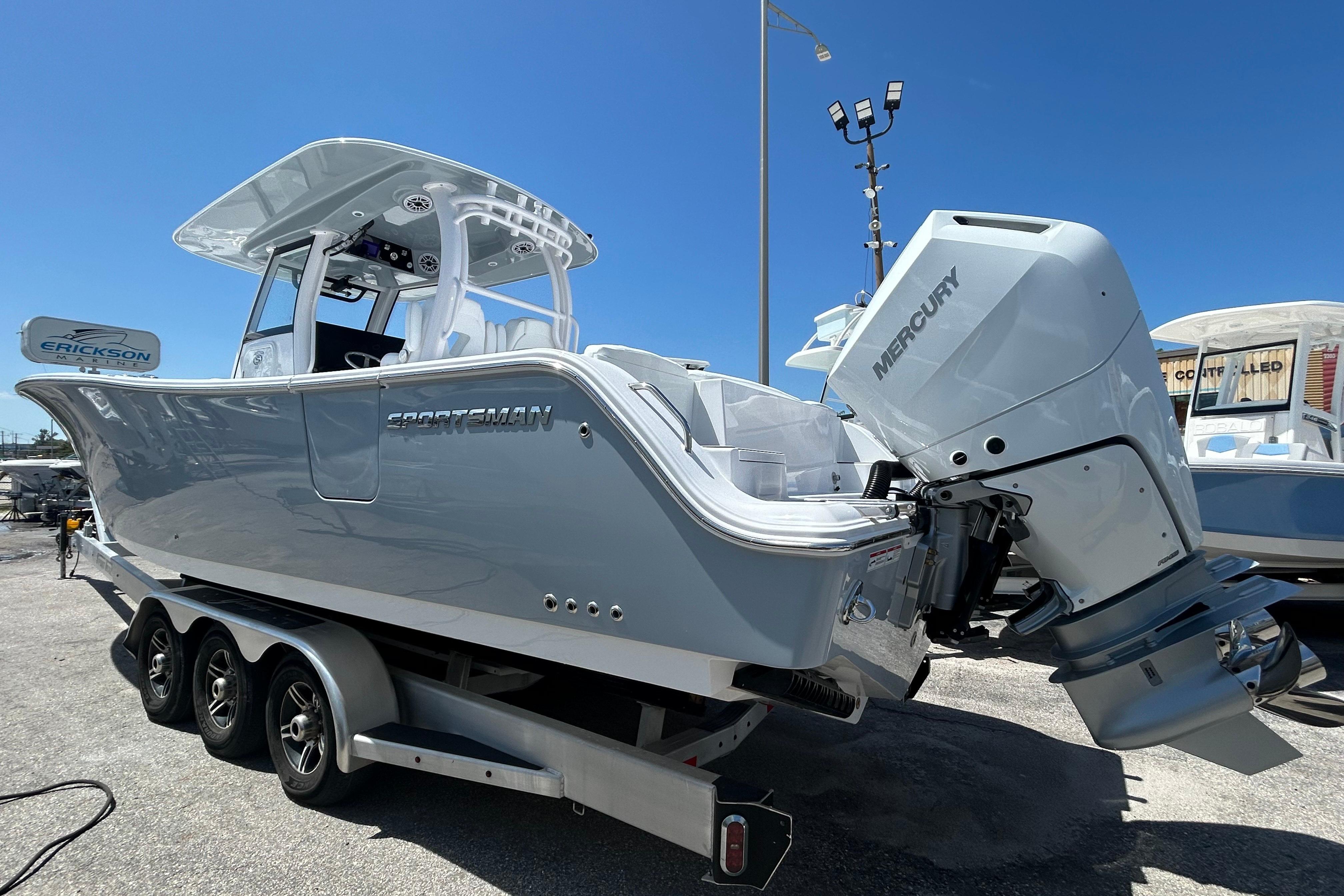 2026 Sportsman Heritage 321 Center Console boat with Mercury engine on trailer.