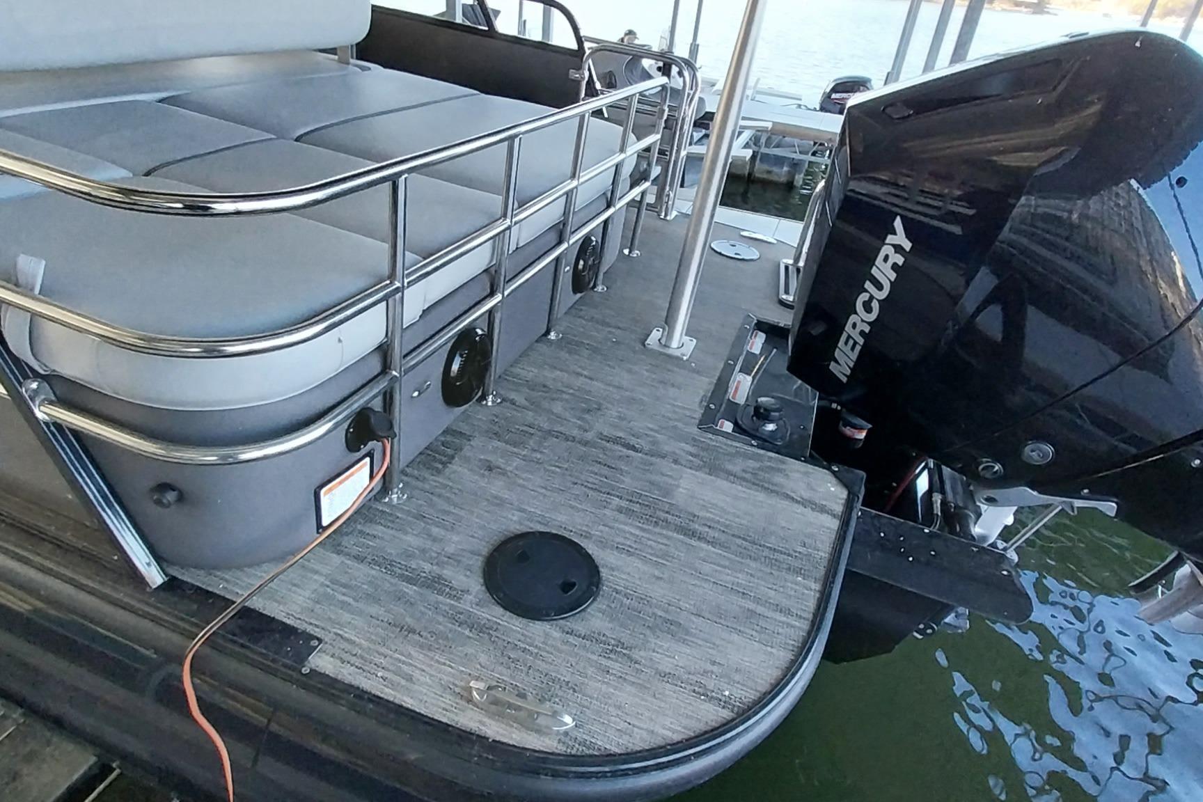 2023 Ranger 2500LS boat with Mercury engine, docked on water.