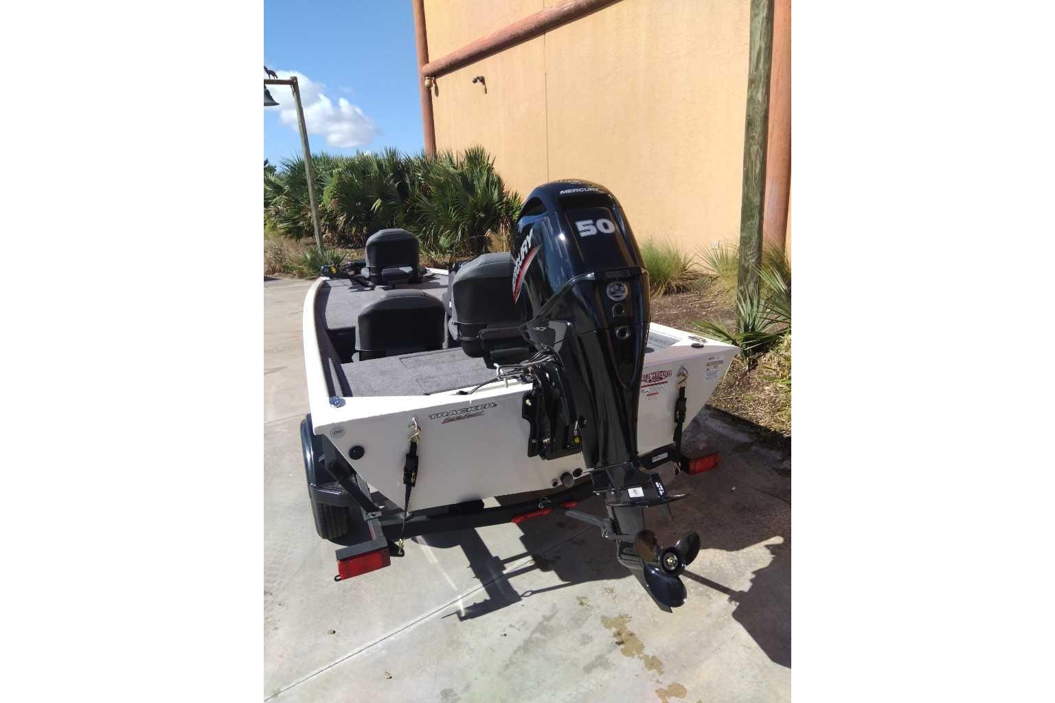 2026 Tracker Pro 170 boat with Mercury 50 HP engine, parked outdoors.