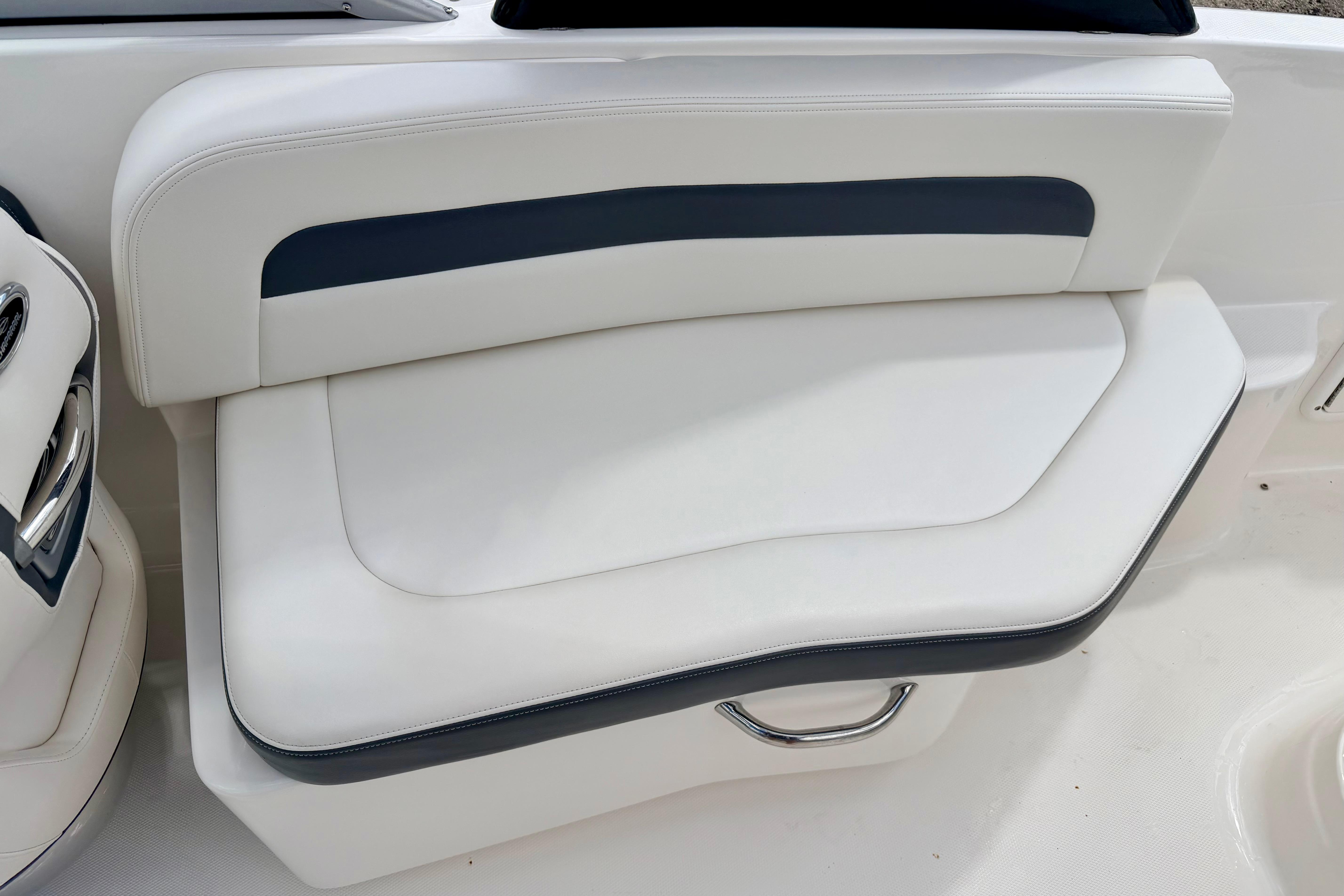 2015 Chaparral Sunesta 264 boat seat with white and navy upholstery.