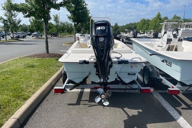 2026 Mako Pro Skiff 13 CC boat with 40 HP engine in parking lot.