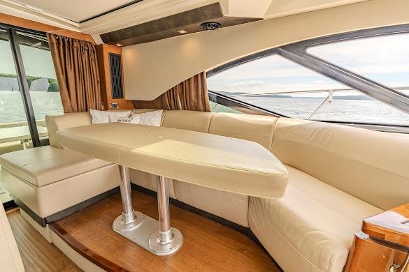 Luxurious interior of 2016 Sea Ray Sundancer 510 yacht with elegant seating and scenic window view.