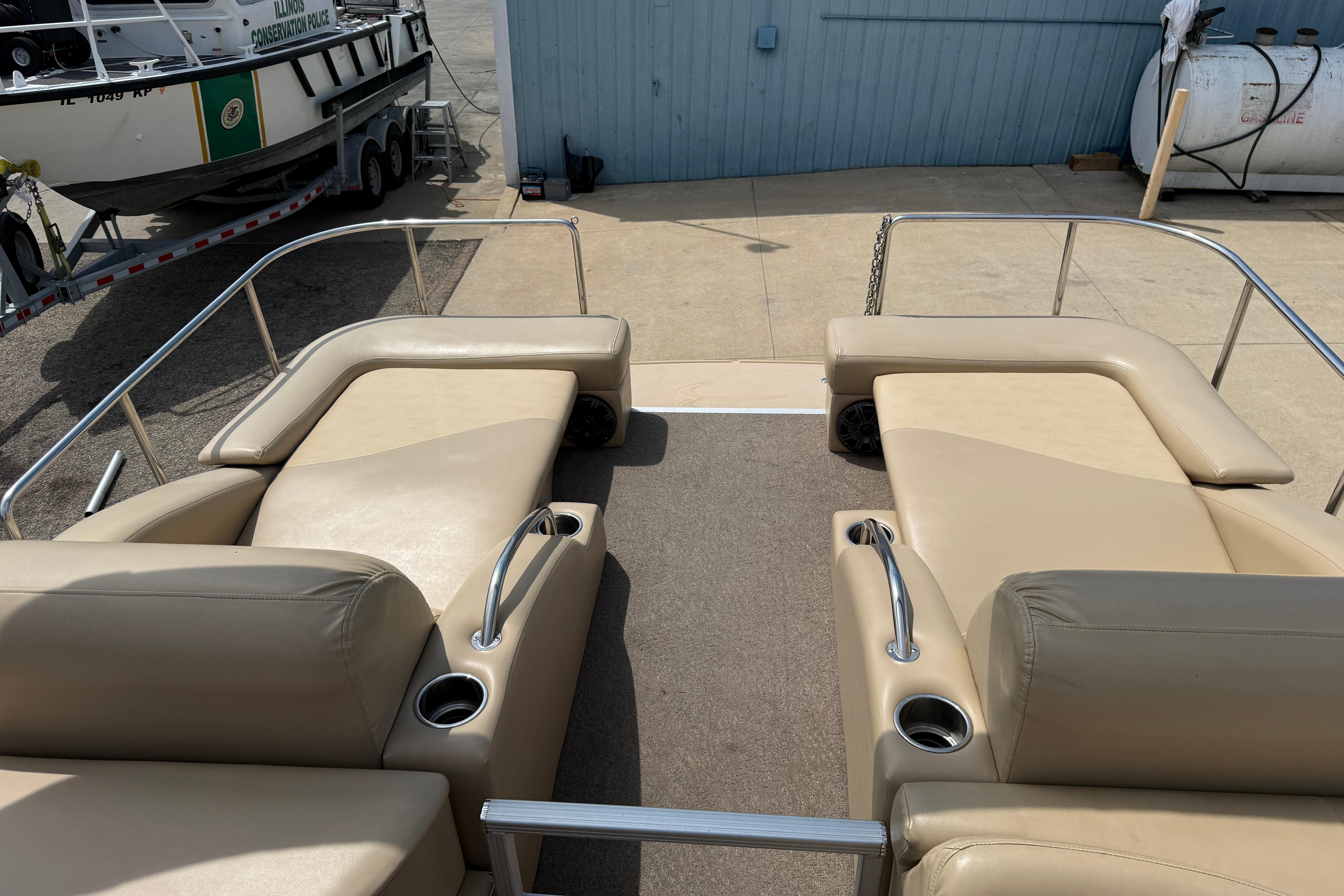 2011 Bennington 2575QCW I/O boat interior with beige seating and cup holders.