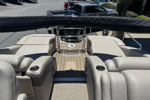 2018 Bennington 23 RCW boat interior with beige seating and cup holders.