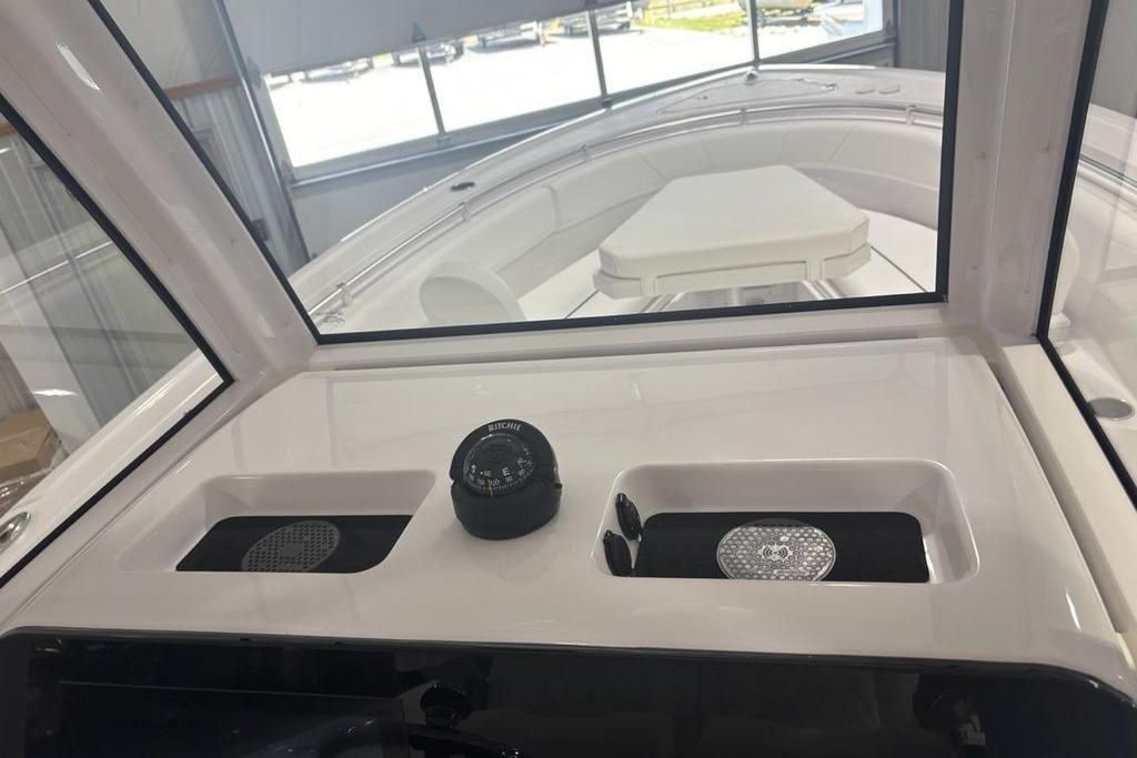 2026 Sportsman Open 252 Center Console boat interior with compass and storage compartments.