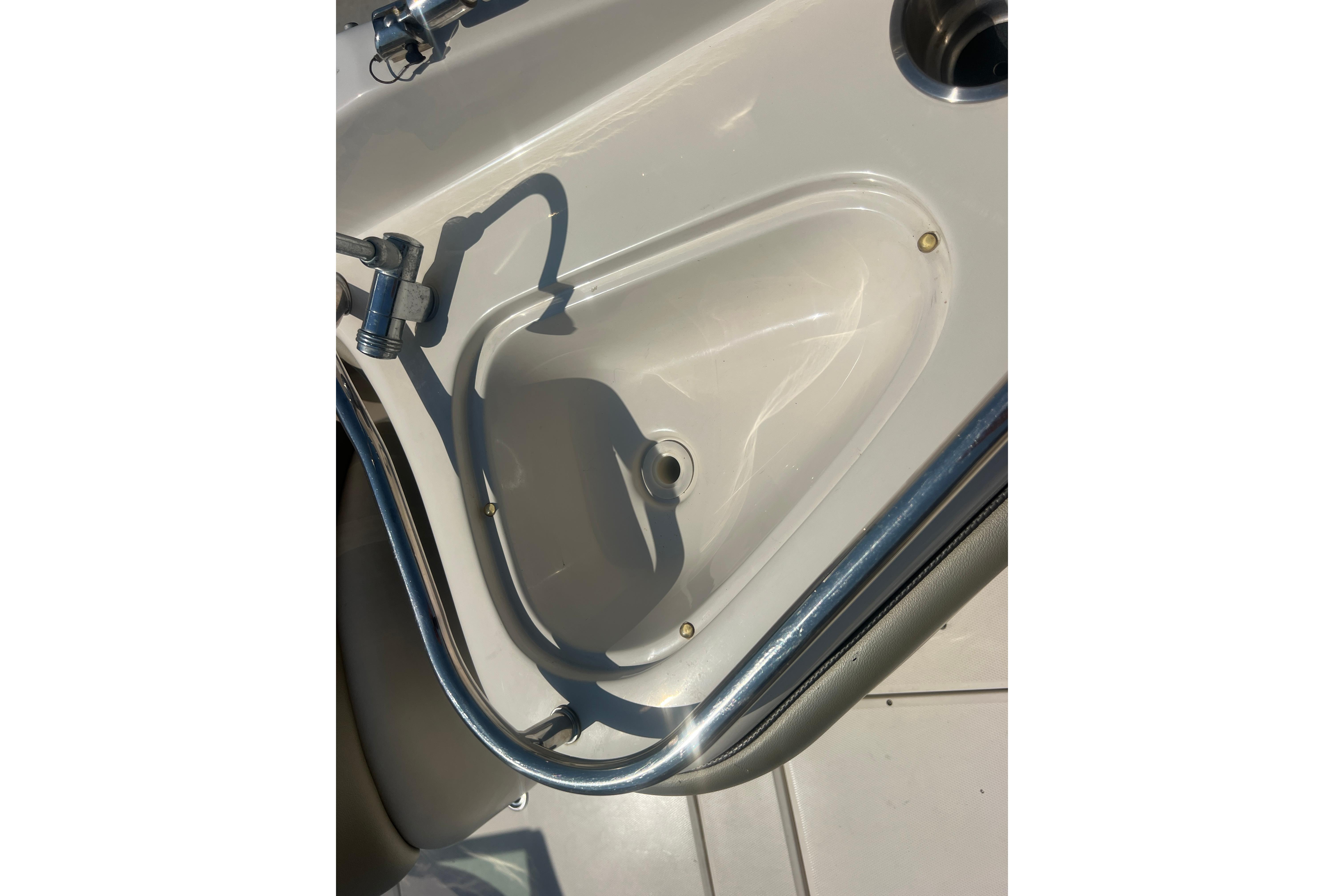 2005 Sea Ray 240 Sundeck boat sink with faucet and stainless steel railing.