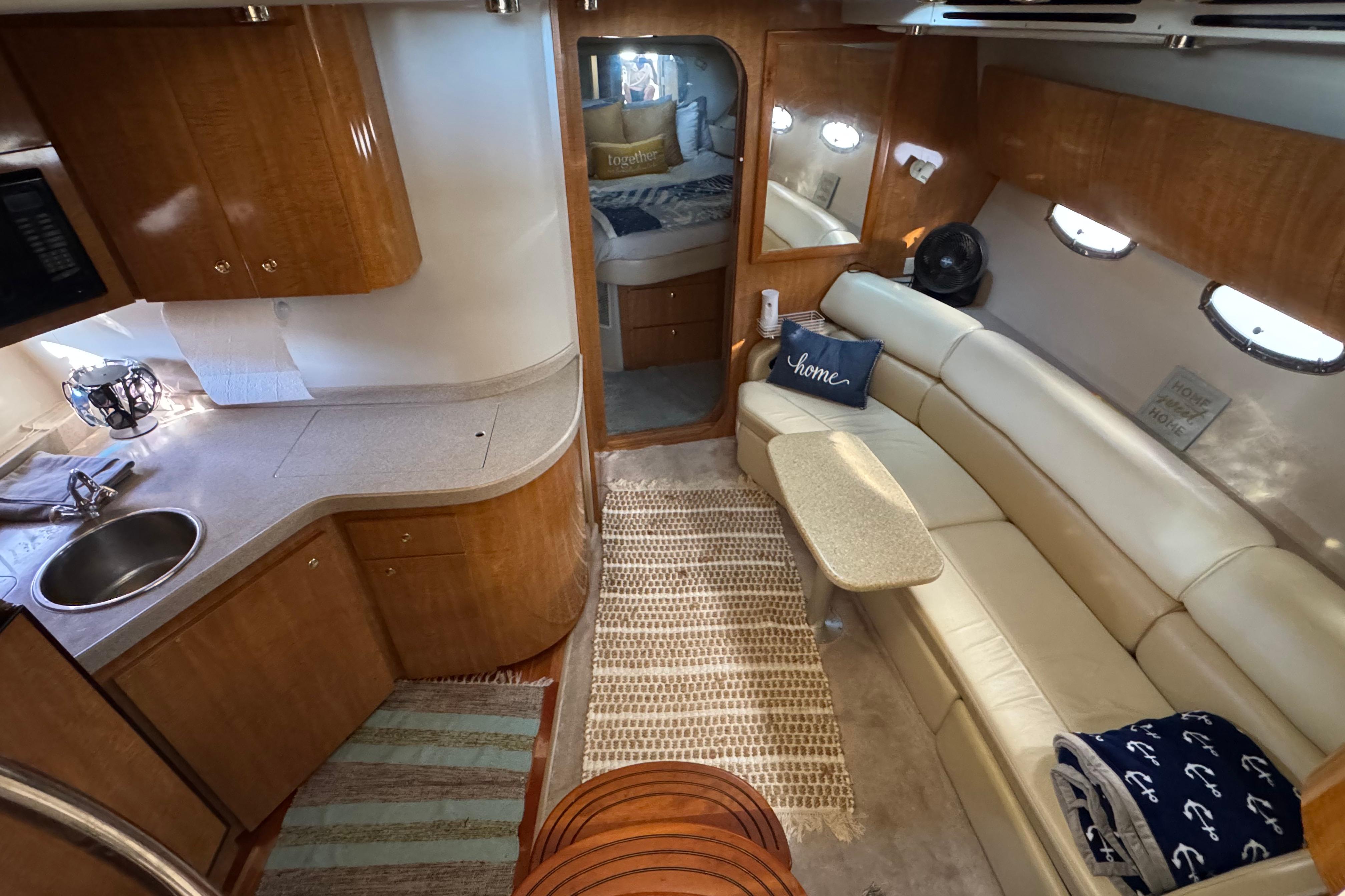 Luxurious interior of a 2007 Regal Commodore 3860 yacht with cozy seating and kitchenette.