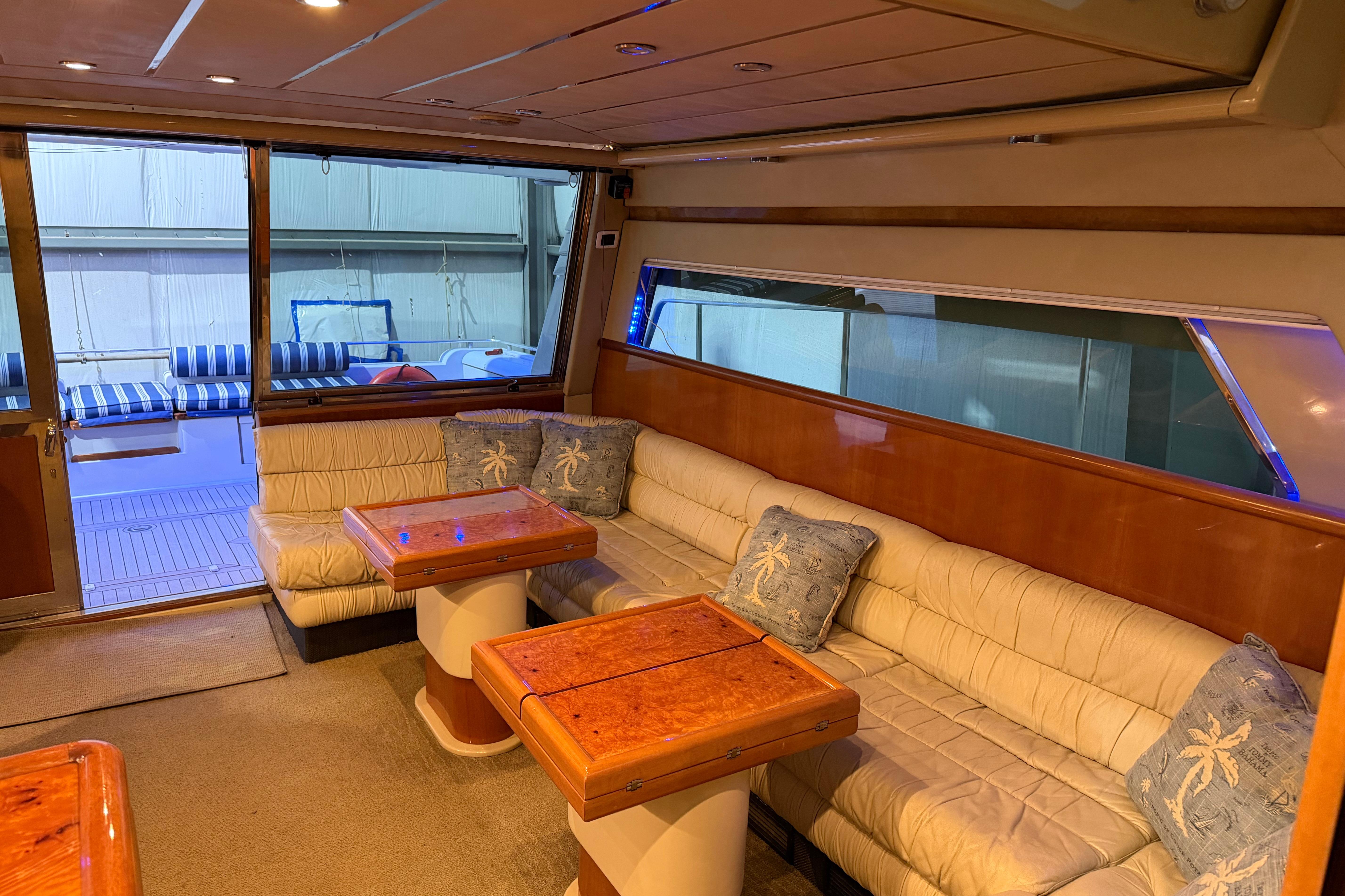 Luxurious interior of 1994 Ferretti Yachts 185 Fly with plush seating and elegant wood finishes.