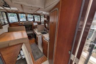 2008 Ranger 25 interior with wood finishes and seating area.