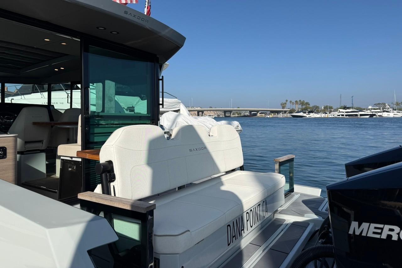 2024 Saxdor 320 GTC yacht docked at Dana Point, featuring sleek design and luxurious seating.