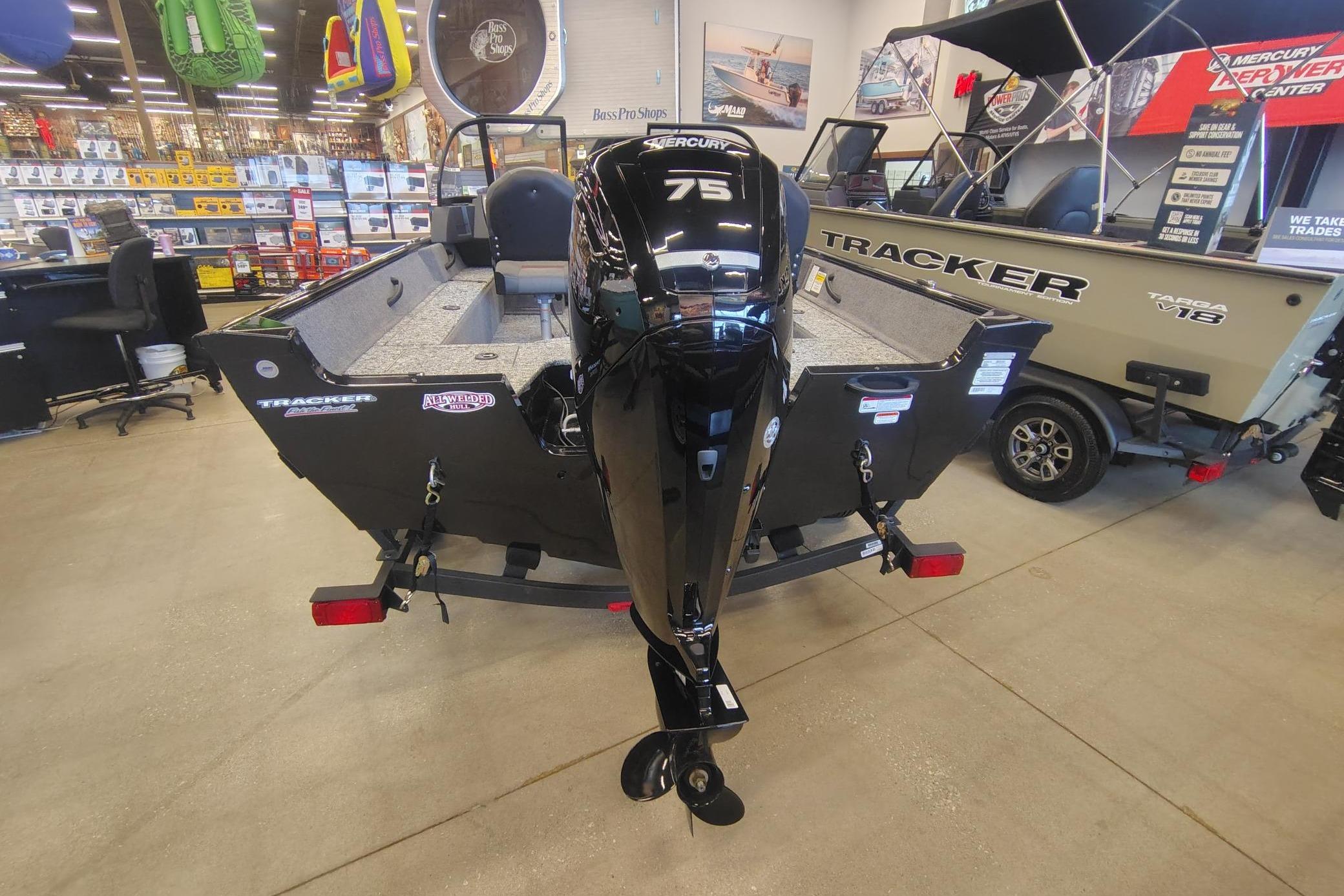 2026 Tracker Pro Guide V-16 WT boat with Mercury 75 engine in showroom.