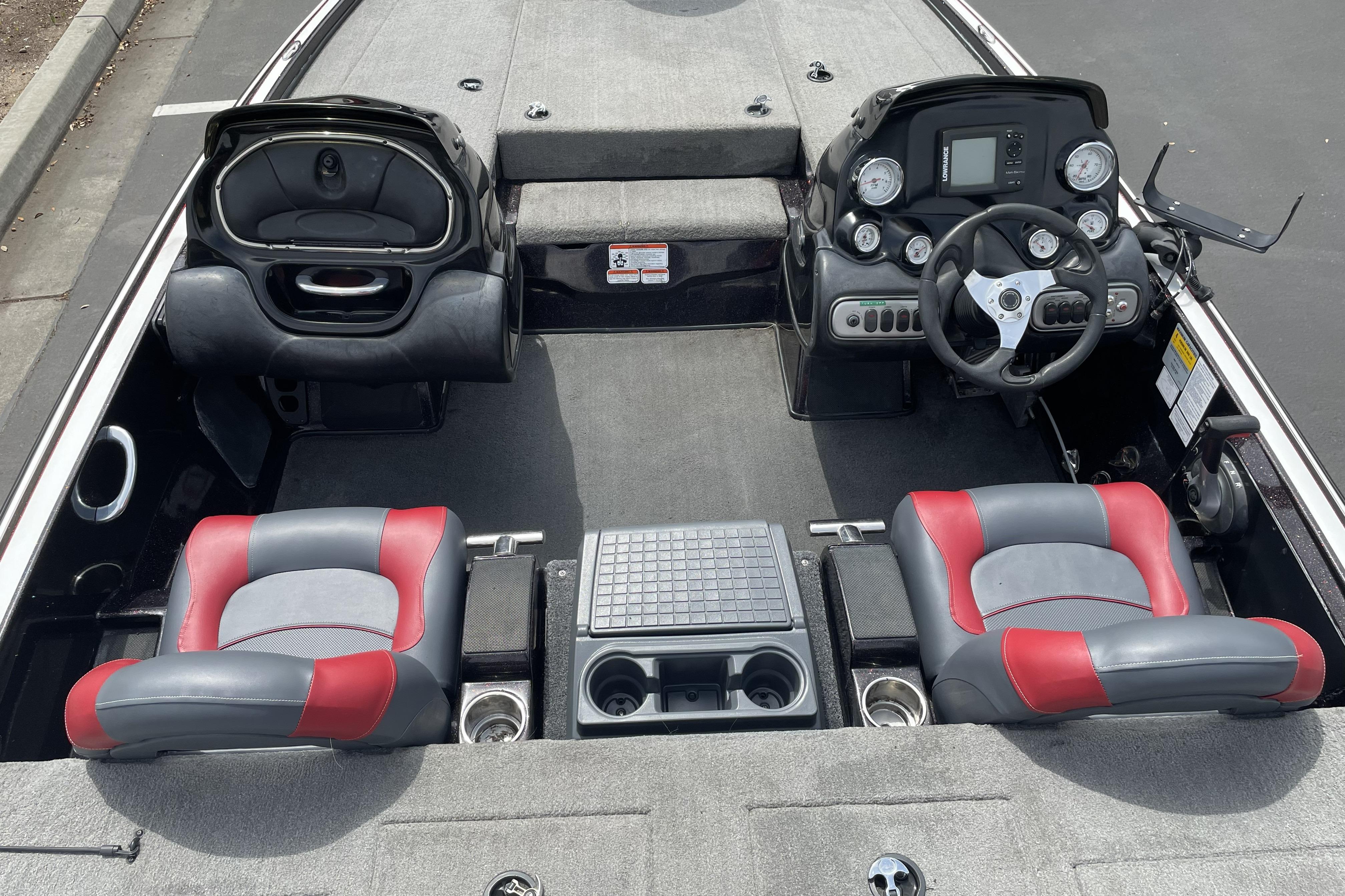 2013 Nitro Z-8 boat interior with red and gray seats, steering console, and storage compartments.
