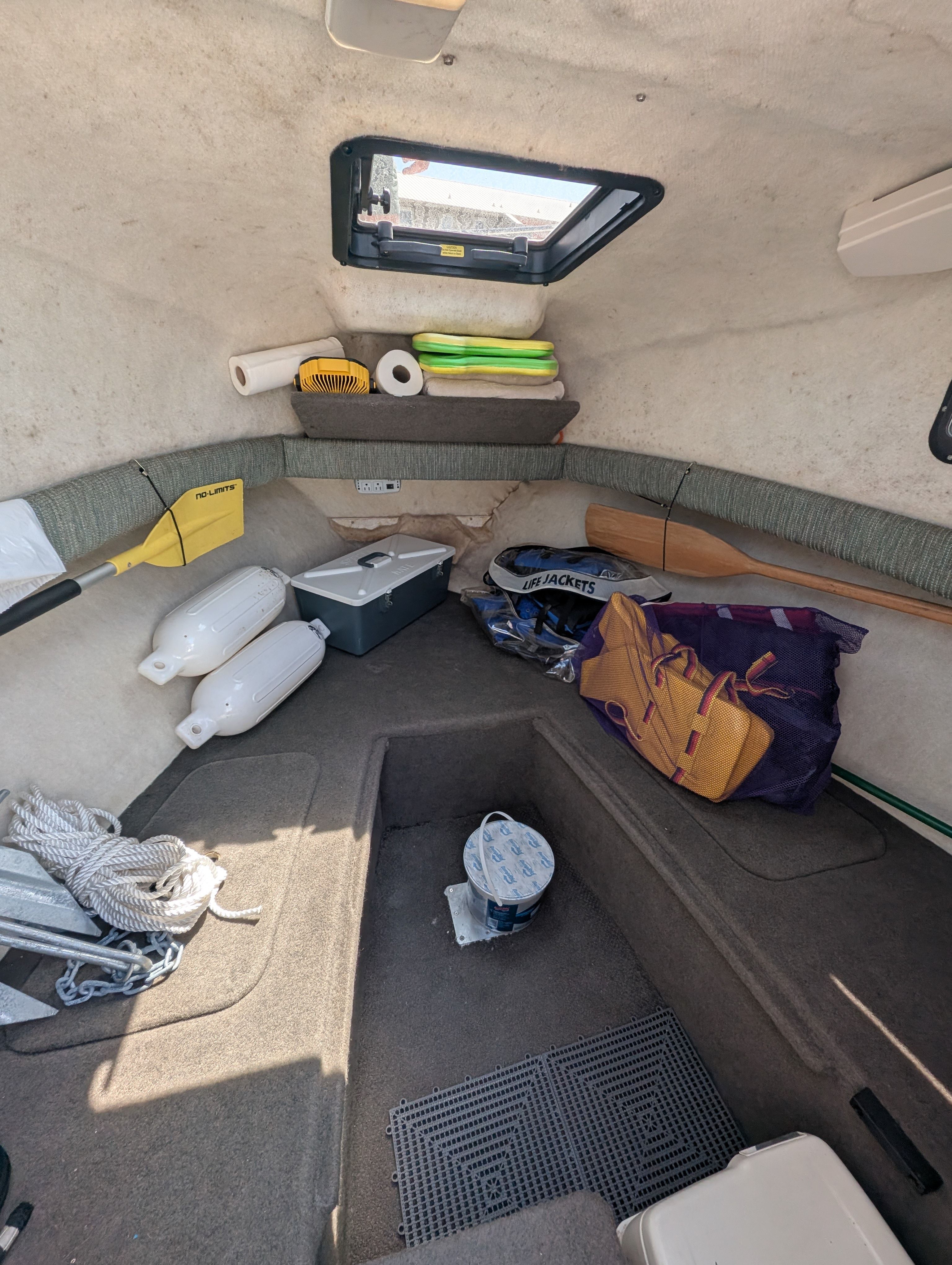 Interior of a 2001 Trophy Bayliner boat with storage and accessories.