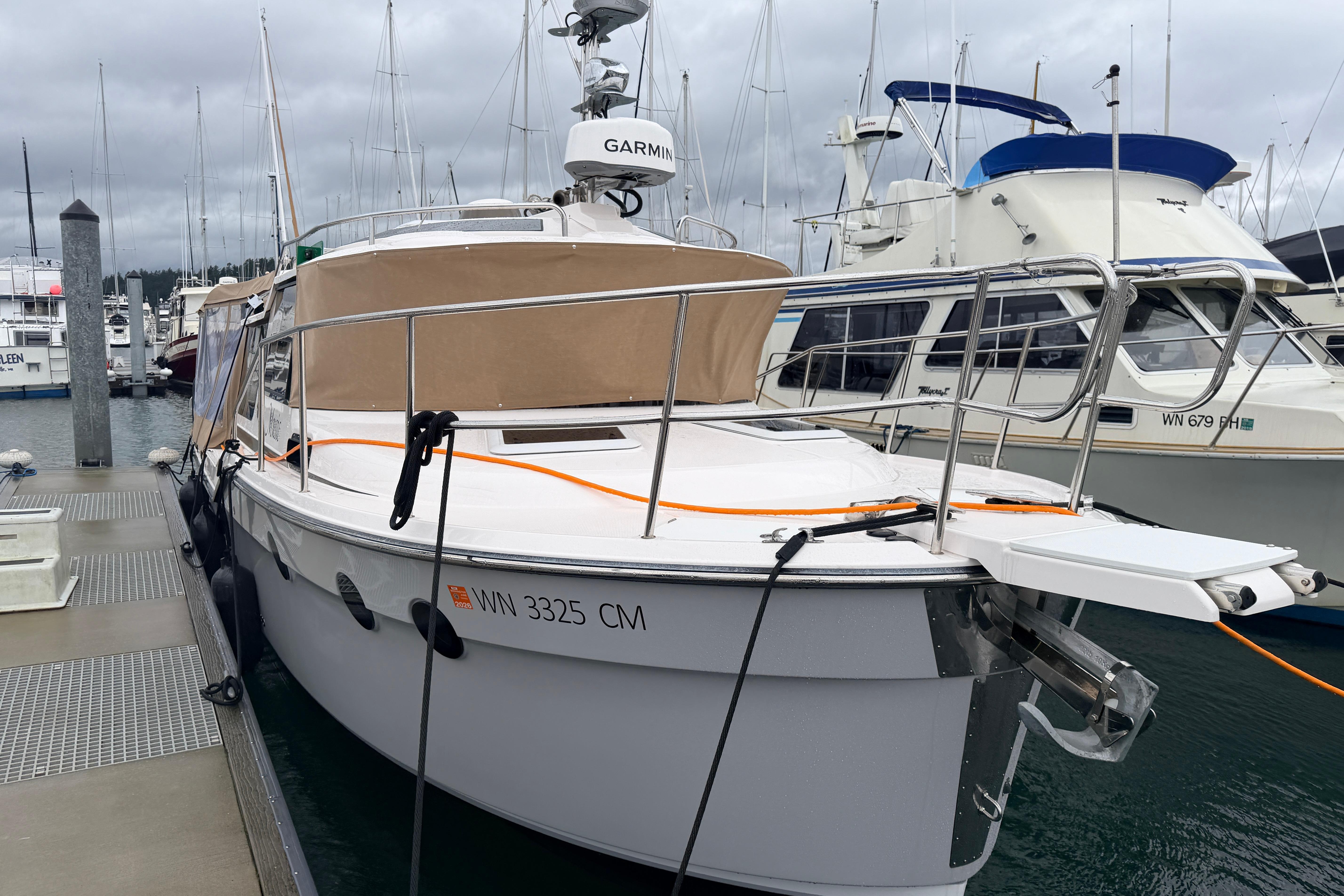 2025 Ranger Tugs R-29 S docked at marina, featuring sleek design and modern equipment.