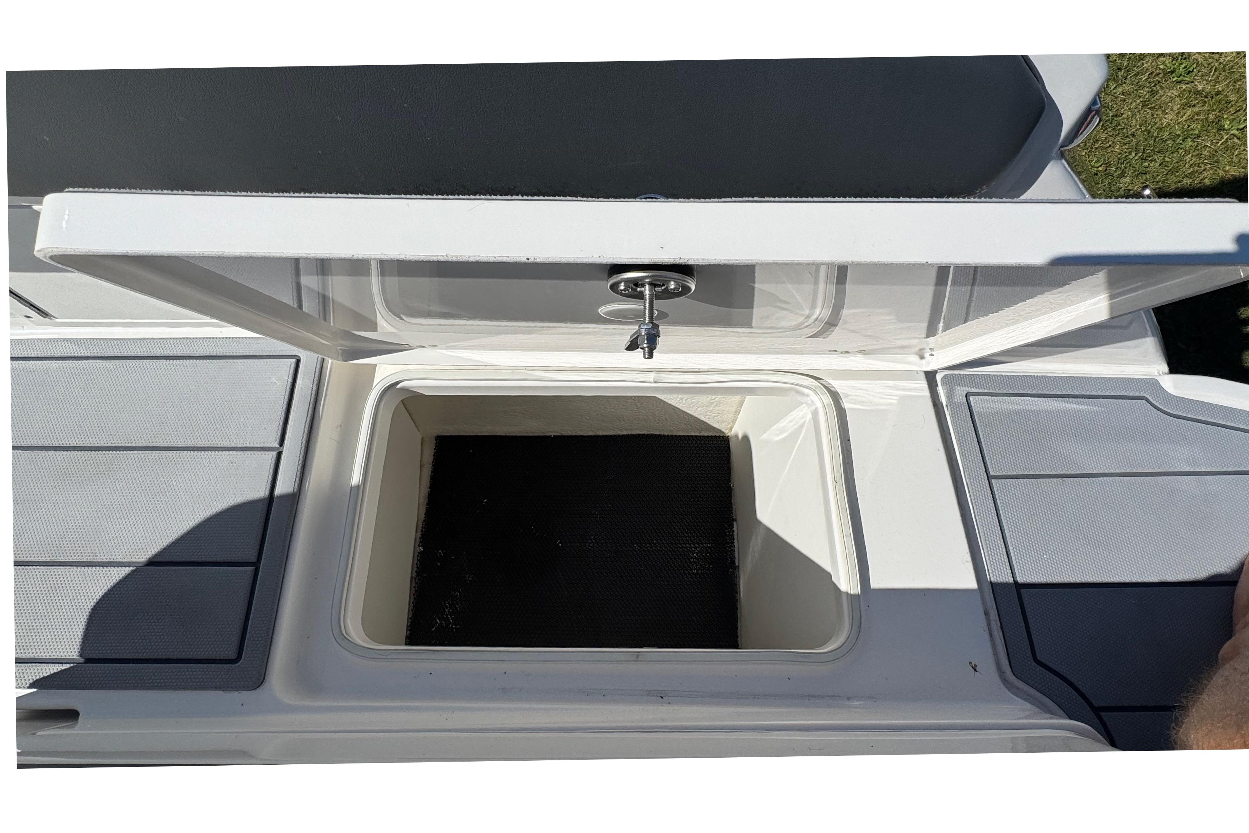 Open storage compartment on 2026 Chaparral SSX 4 boat deck.