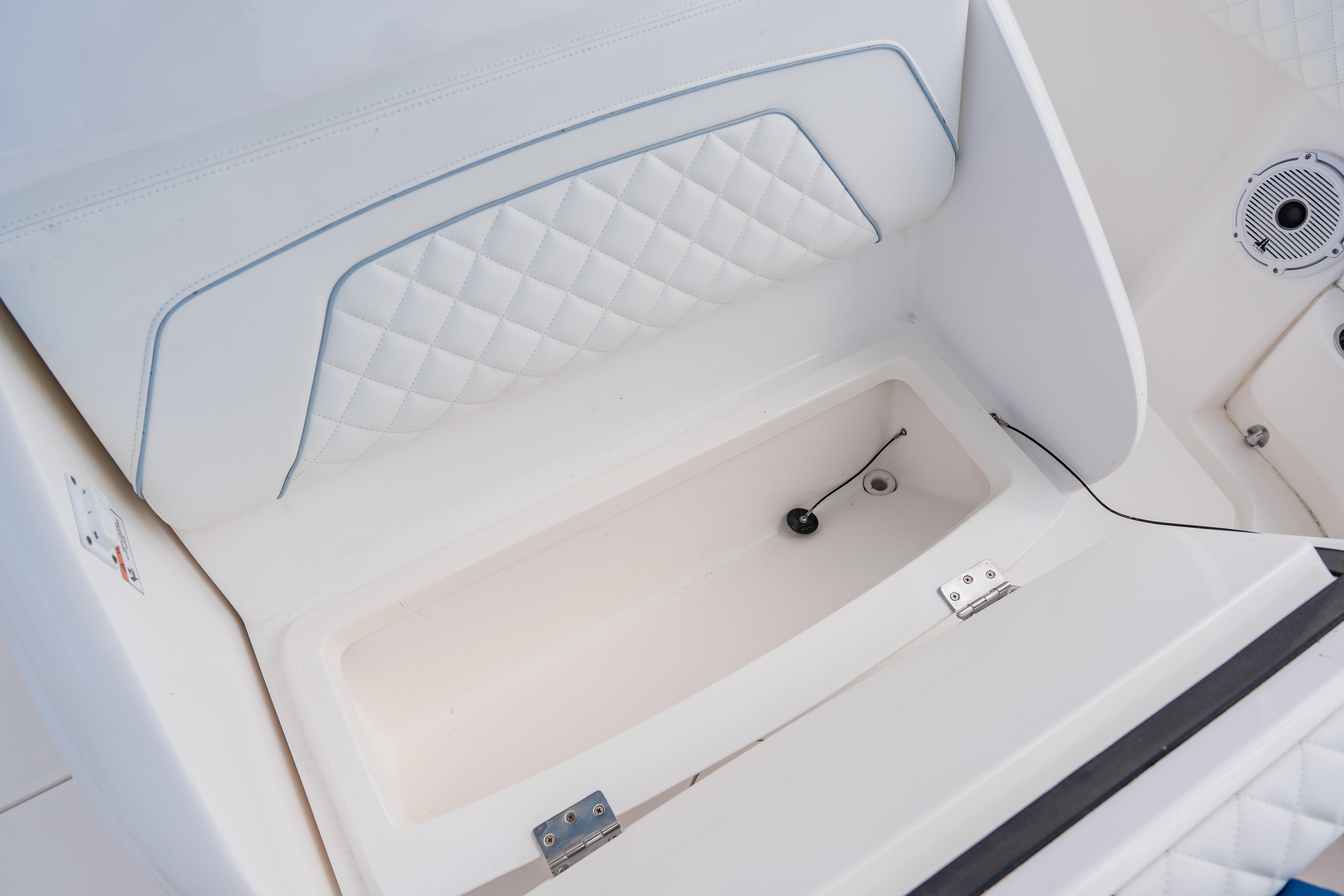 2018 Intrepid 327 Center Console boat interior storage compartment with quilted upholstery.