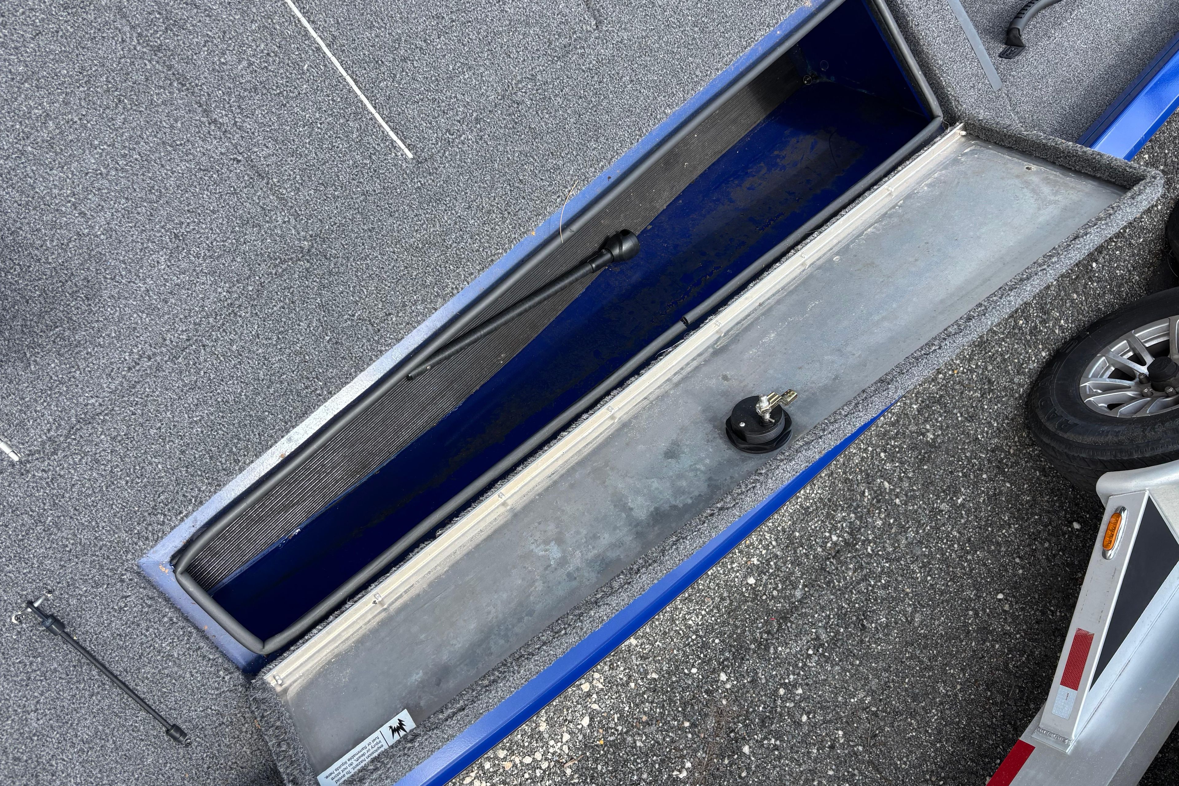 2021 Lowe Stinger 175C boat storage compartment with open lid, showing interior details.